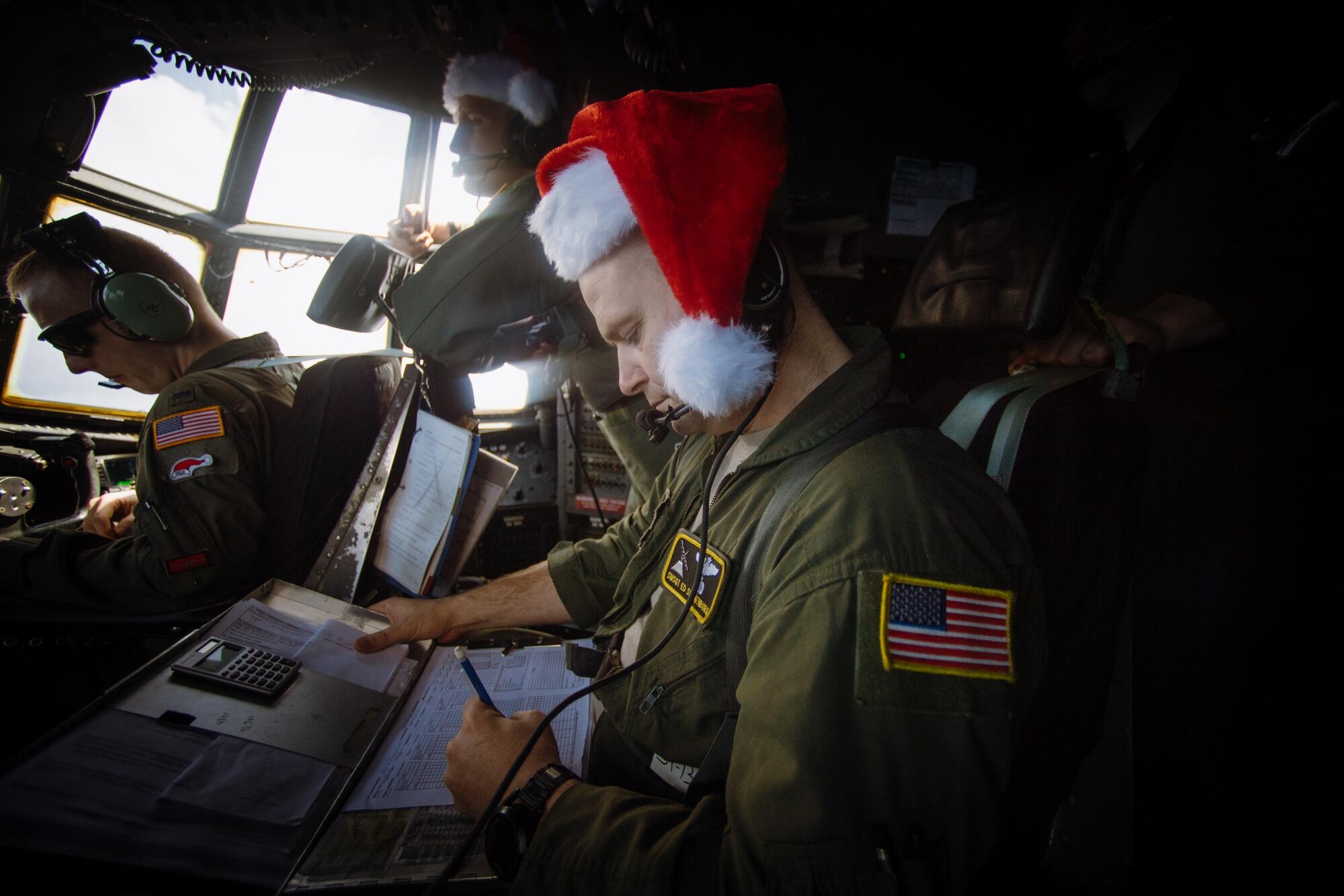 Senior Master Sgt. Ed Sponenburg, 36th Airlift Squadron C-130 Hercules flight engineer, annotates flight information during Operation Christmas Drop over remote Micronesian islands, Dec. 5, 2016. Operation Christmas Drop is a training mission which helps the 374th Airlift Wing, Yokota AB, Japan, along with Japan Air Self-Defense Force and Royal Australian Air Force, to maintain and develop combat readiness through sustainable aircraft generation/recovery while practicing low-cost, low-altitude airdrops. (U.S. Air Force photo by Senior Airman Delano Scott/Released)