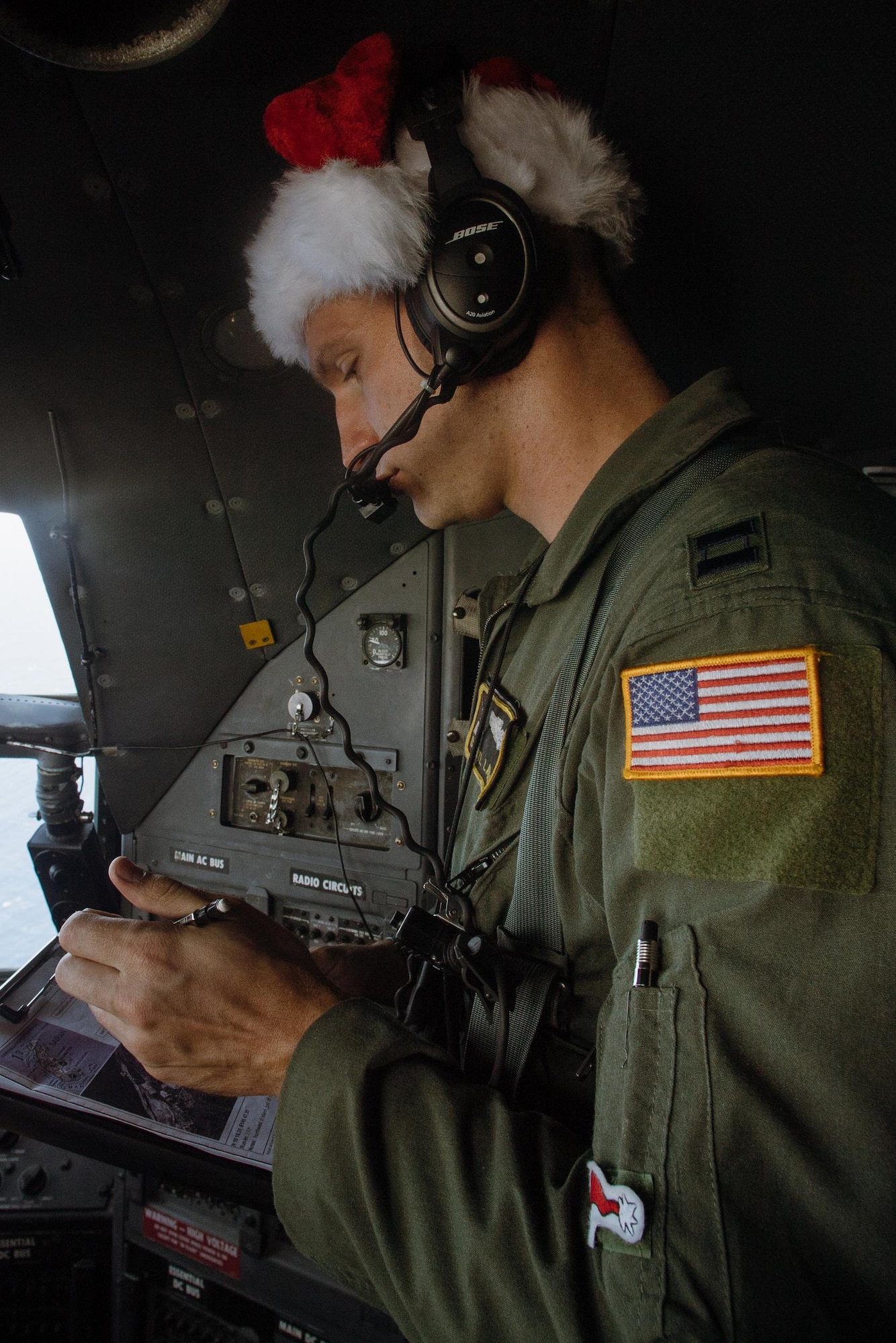 Capt. Darryl Lawlor, 36th Airlift Squadron C-130 Hercules navigator, checks a map during Operation Christmas Drop over remote Micronesian islands, Dec. 5, 2016. Australian and Japanese aircrews joined U.S. Airmen to execute the Humanitarian Aid/Disaster Relief training event where C-130 aircrews perform low-cost, low-altitude airdrops to drop zones while providing critical supplies to 56 islands. (U.S. Air Force photo by Senior Airman Delano Scott/Released)