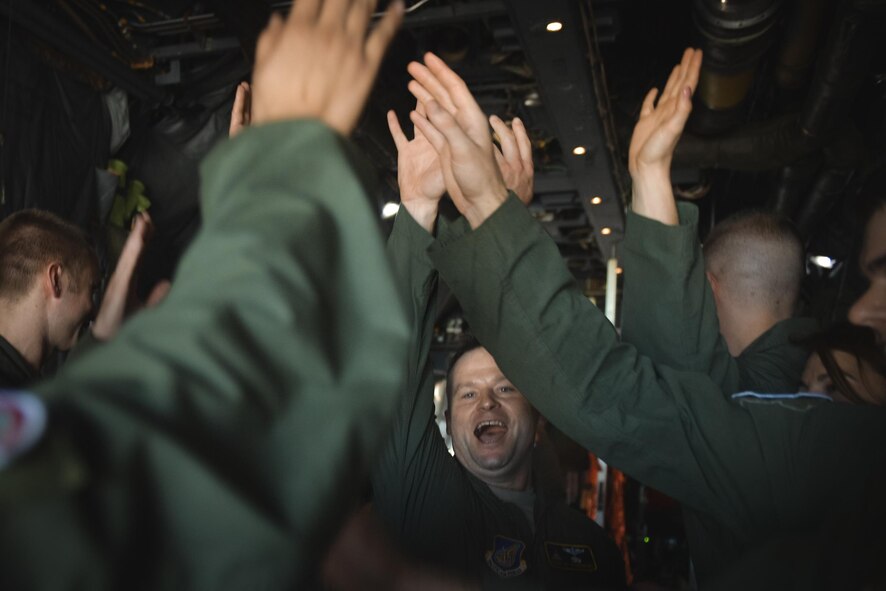 C-130 Hercules crewmembers cheer before starting their mission of delivering bundles during Operation Christmas Drop 2016 at Andersen Air Force Base, Guam, Dec. 6, 2016. This year, the Japan Air Self-Defense Force, Royal Australian Air Force and U.S. Air Force worked together to continue the tradition of air dropping tools, food, clothing and toys throughout the Pacific. (U.S. Air Force photo by Senior Airman Delano Scott/Released)