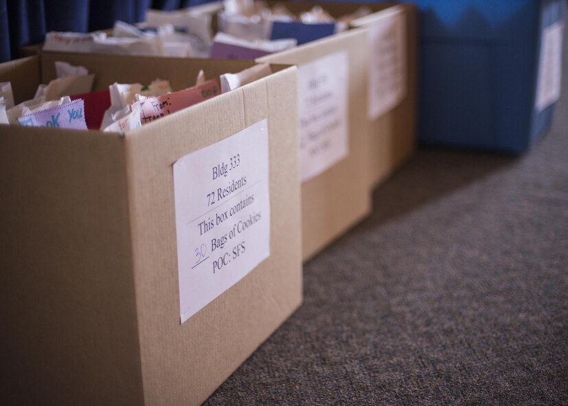 Packages of cookies are placed into boxes, to be distributed to the various base dormitories, for Holloman’s annual Airman Cookie Drive at the Community Activity Center at Holloman Air Force Base, N.M. on Dec 4, 2016. Members of the First Sergeant’s Council distributed the cookies to Airmen living in the base dorms Dec. 5, 2016. (U.S. Air Force photo by Airman 1st Class Alexis P. Docherty) 