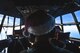 Senior Master Sgt. Ed Sponenburg, 36th Airlift Squadron C-130 Hercules flight engineer, observes the skies during Operation Christmas Drop 2016 over remote Micronesian islands, Dec. 6, 2016. This year marks 65 years of Operation Christmas Drop which provides joint airlift training opportunities for both peace and wartime efforts. (U.S. Air Force photo by Senior Airman Delano Scott/Released)
