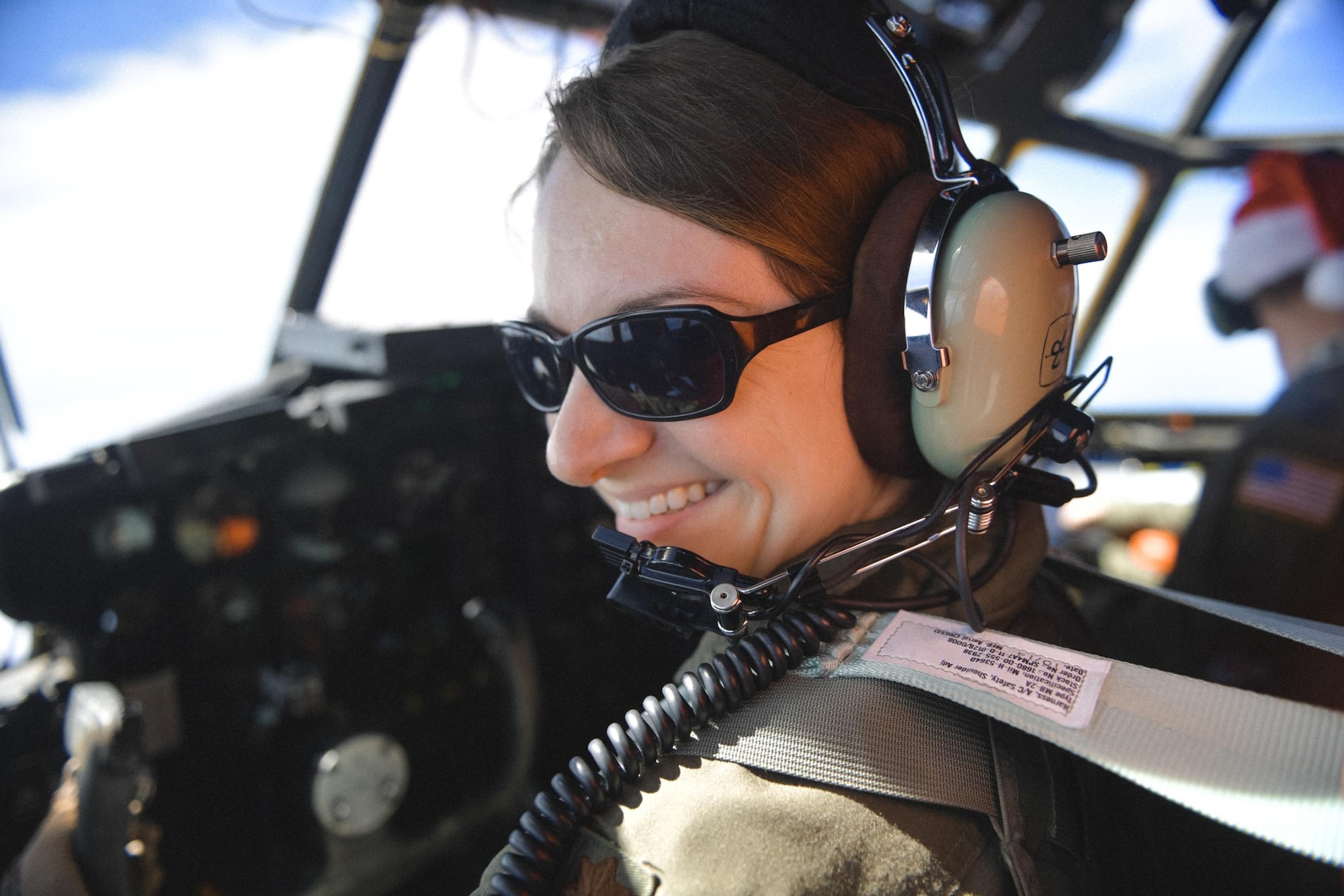 Maj. Dominique Haig, 36th Airlift Squadron C-130 Hercules pilot, flies over remote Micronesian islands during Operation Christmas Drop 2016, Dec. 6, 2016. This year the Japan Air Self-Defense Force, Royal Australian Air Force and U.S. Air Force work together to continue the tradition of air dropping tools, food, clothing and toys throughout the Pacific. (U.S. Air Force photo by Senior Airman Delano Scott/Released)