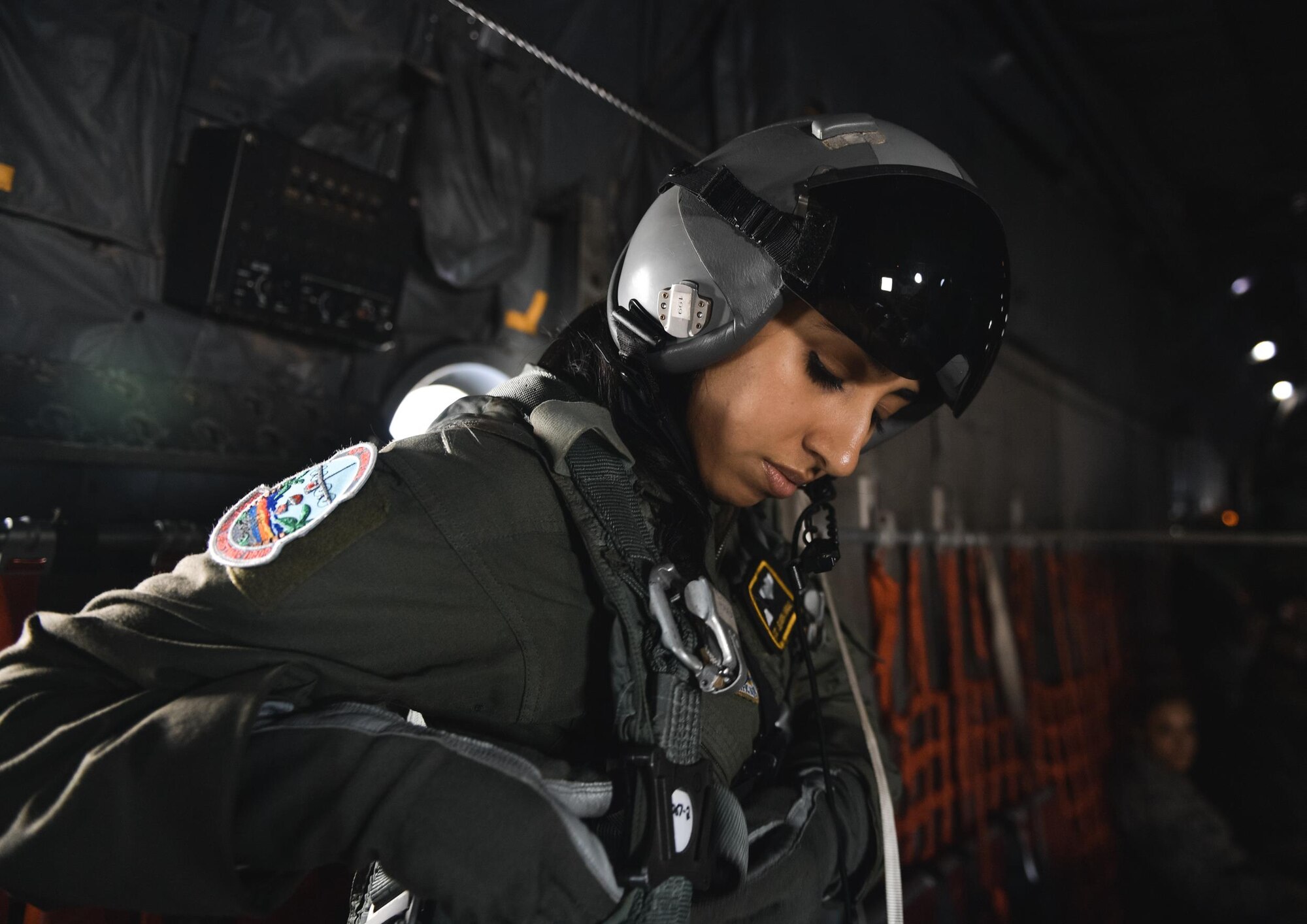 Airman 1st Class Alejandra Vargas, 36th Airlift Squadron C-130 Hercules loadmaster, preps her flight equipment over remote Micronesian islands during Operation Christmas Drop 2016, Dec. 6, 2016. Operation Christmas Drop highlights the U.S. and allied airpower capabilities to orient and respond to activities in peacetime and crisis. In addition to delivering critical supplies to those in need, Operation Christmas Drop provides specific training to U.S. and allied aircrews, enabling theater-wide airpower. (U.S. Air Force photo by Senior Airman Delano Scott/Released)