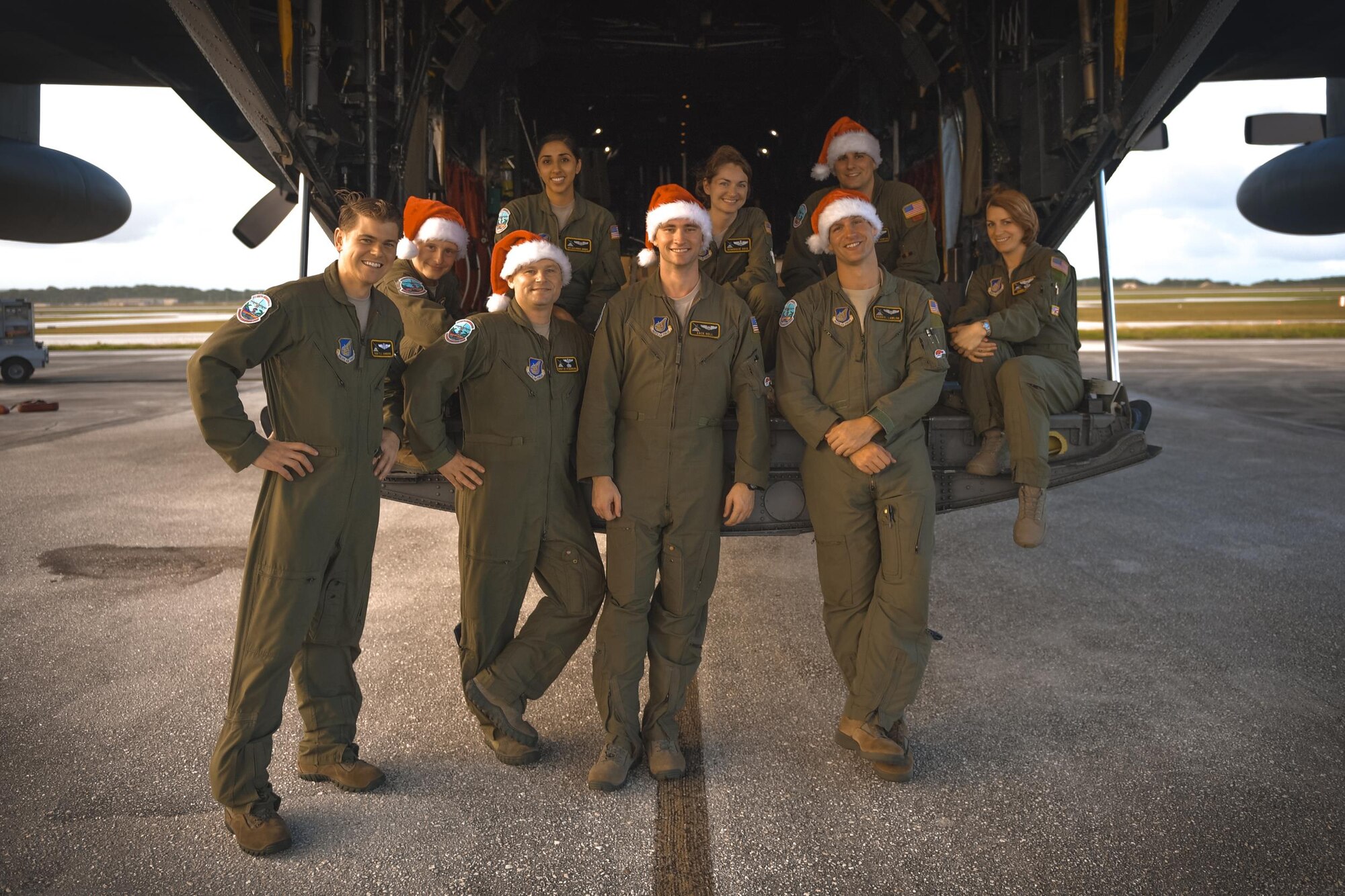 C-130 Hercules crewmembers pose for a photo after delivering low cost, low altitude humanitarian airdrops during Operation Christmas Drop 2016 at Andersen Air Force Base, Guam, Dec. 6, 2016. Operation Christmas Drop highlights the U.S. and allied airpower capabilities to orient and respond to activities in peacetime and crisis. In addition to delivering critical supplies to those in need, Operation Christmas Drop provides specific training to U.S. and allied aircrews, enabling theater-wide airpower. (U.S. Air Force photo by Senior Airman Delano Scott/Released)