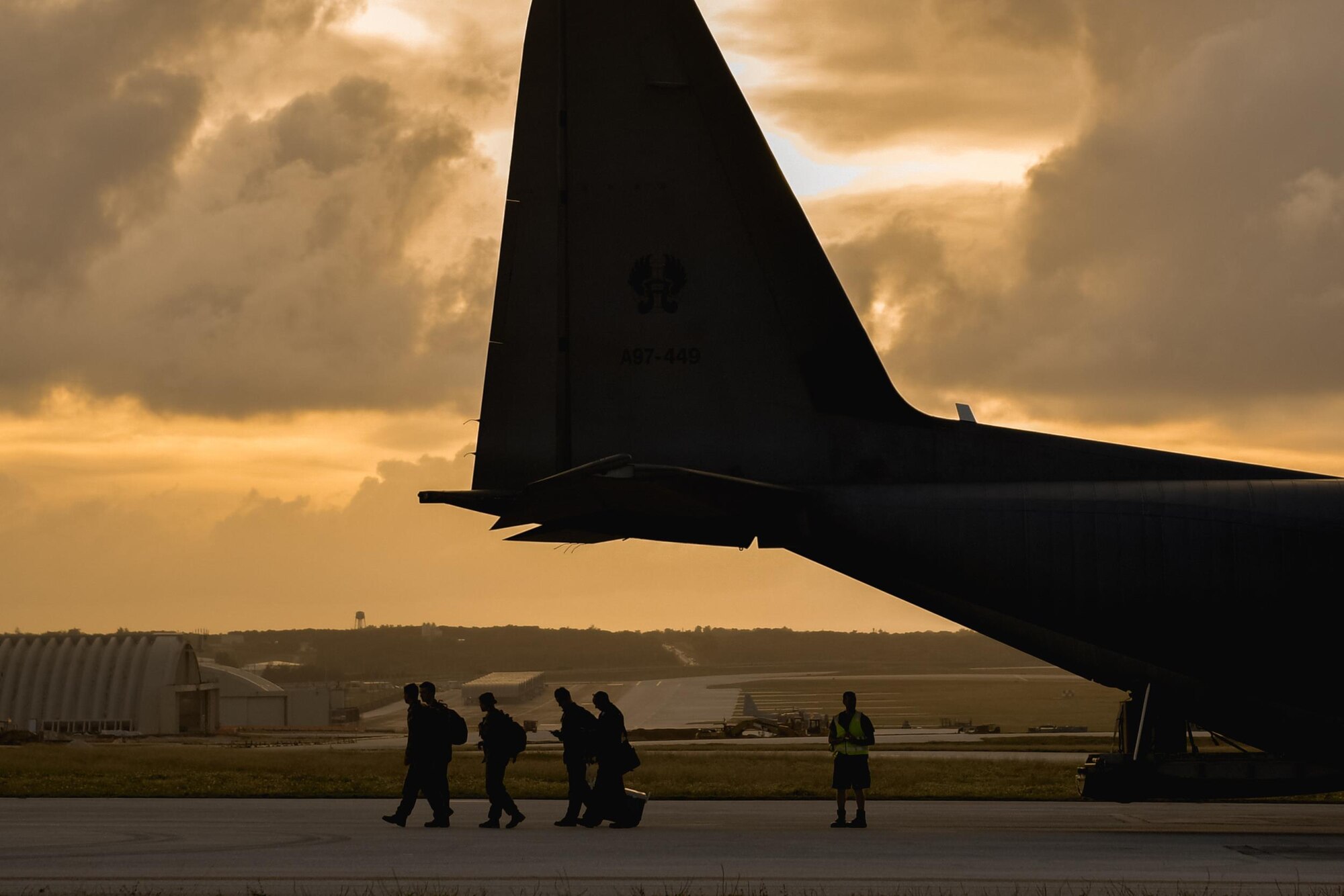 Crewmembers of a Royal Australian Air Force C-130J Super Hercules exit the aircraft during Operation Christmas Drop 2016 at Andersen Air Force Base, Guam, Dec. 6, 2016. Operation Christmas Drop highlights the U.S. and allied airpower capabilities to orient and respond to activities in peacetime and crisis. (U.S. Air Force photo by Senior Airman Delano Scott/Released)