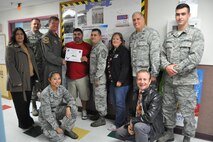 Omar Matos, 47th Force Support Squadron youth center director (left center), accepts the “XLer of the Week” award from Col. Thomas Shank (left), 47th Flying Training Wing commander, and Chief Master Sgt. George Richey (center), 47th FTW command chief, on Laughlin Air Force Base, Texas, Nov. 16, 2016. The XLer is a weekly award chosen by wing leadership and is presented to those who consistently make outstanding contributions to their unit and Laughlin. (U.S. Air Force photo/1st Lt. Isabel Crump)