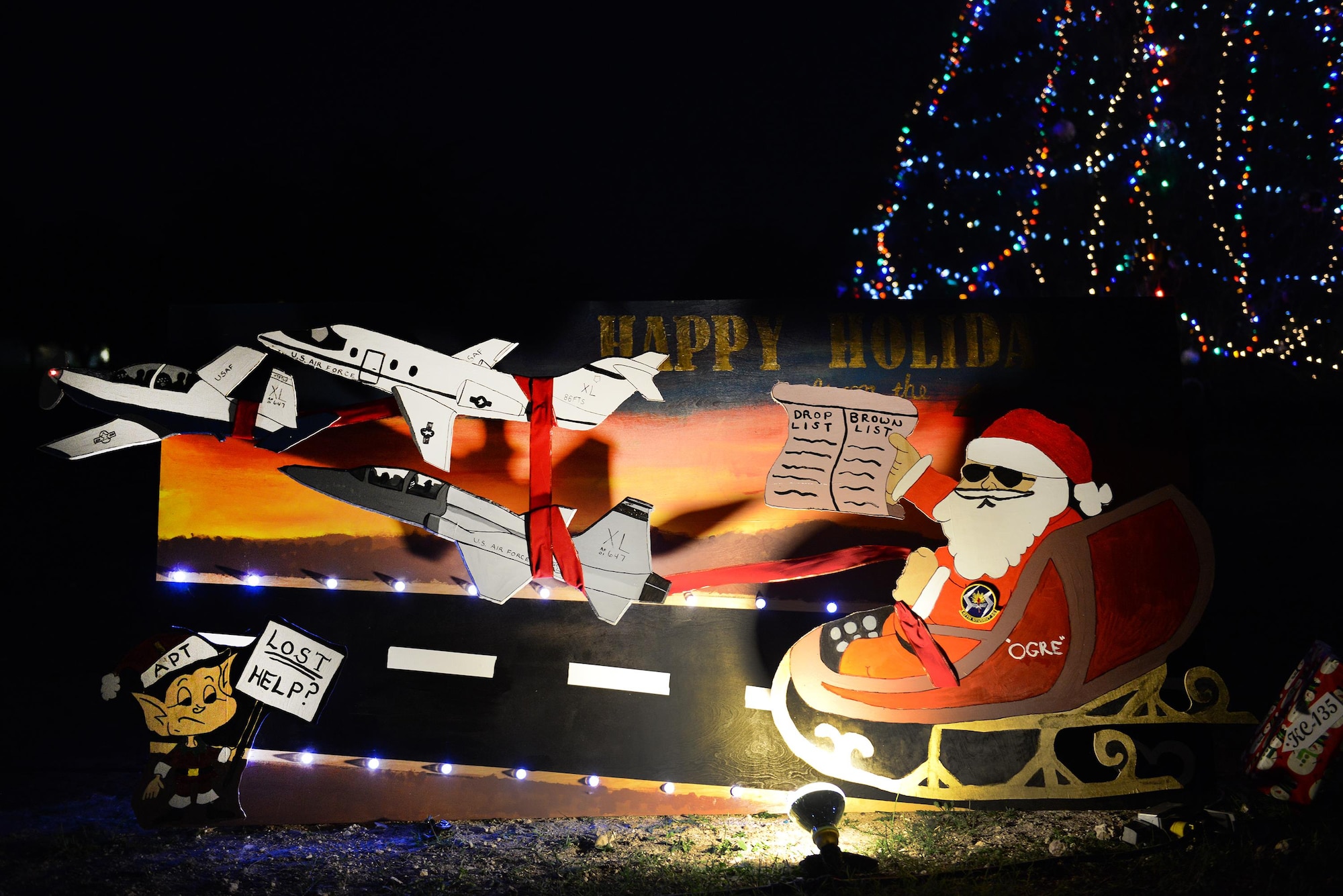 The 47th Student Squadron holiday card sits by the Christmas tree on Laughlin Air Force Base Nov. 30. The card received the Holiday and Squadron Spirit award for the 2016 Holiday Card Contest. (U.S. Air Force photo/Airman 1st Class Benjamin N. Valmoja)