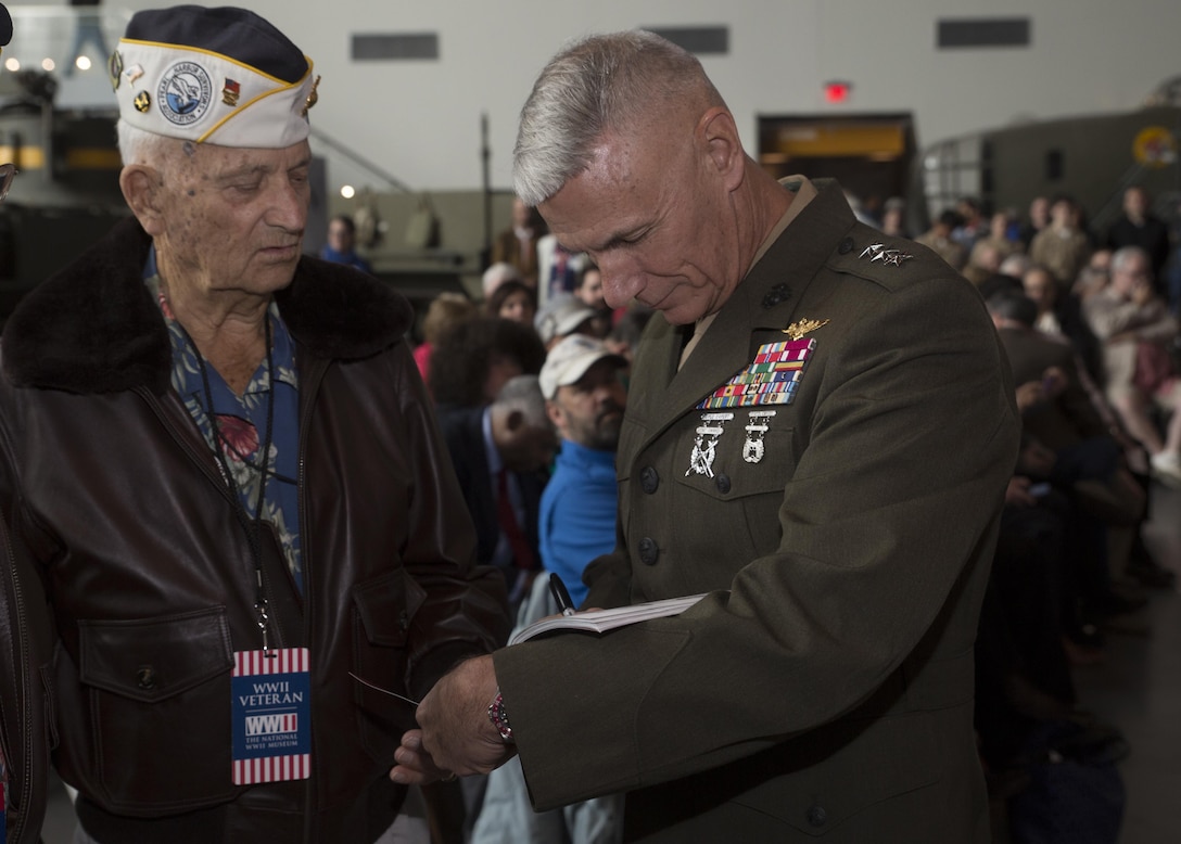 Lt. Gen. Rex C. McMillian (right), commander of Marine Forces Reserve and Marine Forces North, signs a book for retired Marine Corps Sgt. Maj. William M. Braddock, a veteran of World War II, at a commemorative ceremony at the National World War II Museum, Dec. 7, 2016, for the 75th anniversary of the attack on Pearl Harbor. The event honored the service members who were present during the fateful attack on Dec. 7, 1941. During World War II, by September of 1945, Reserve Marines made up 70 percent of total wartime Marine Corps personnel. For information on the history and heritage of the Marine Corps Reserve as well as current Marine stories and upcoming Centennial events, please visit www.marines.mil/usmcr100. (U.S. Marine Corps photo by Sgt. Ian Leones)