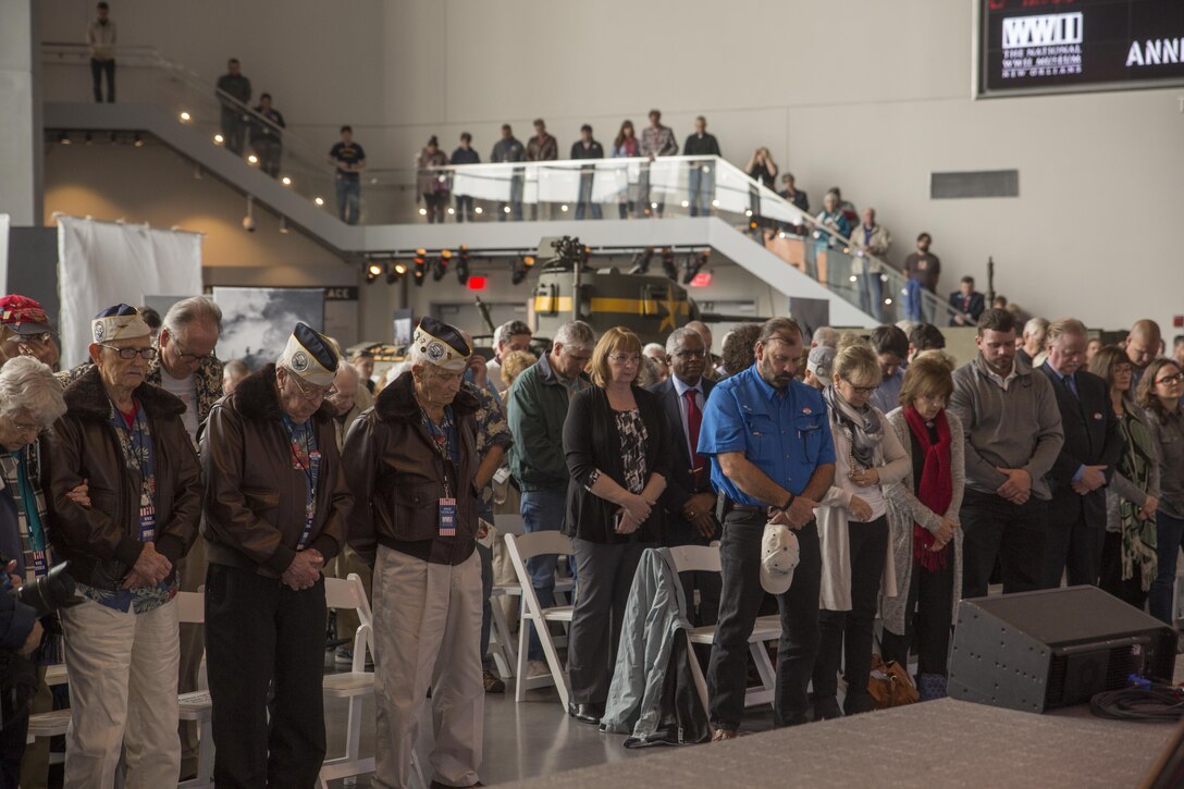 Military veterans and members of the local community bow their heads in a moment of silence during a commemorative ceremony at the National World War II Museum, Dec. 7, 2016, for the 75th anniversary of the attack on Pearl Harbor. The event honored the service members who were present during the fateful attack on Dec. 7, 1941. During World War II, by September of 1945, Reserve Marines made up 70 percent of total wartime Marine Corps personnel. For information on the history and heritage of the Marine Corps Reserve as well as current Marine stories and upcoming Centennial events, please visit www.marines.mil/usmcr100. (U.S. Marine Corps photo by Sgt. Ian Leones)