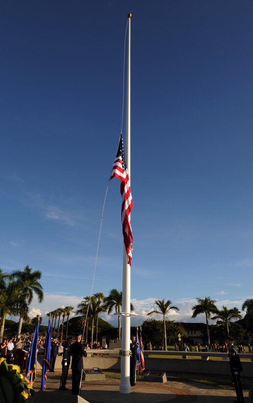 Members of the Hickam Honor Guard raise the American flag to half-mast at the 75th Commemoration of the Dec. 7, 1941 attack on Hickam Field ceremony  Dec. 7, 2016, at Joint Base Pearl Harbor-Hickam, Hawaii. The attacks on seven bases throughout Oahu precipitated America's entry into World War II, and the annual commemoration ceremony is designed to foster reflection, remembrance, and understanding for those affected by the events that took place 75 years ago. (U.S. Air Force photo by Tech. Sgt. Nathan Allen)
