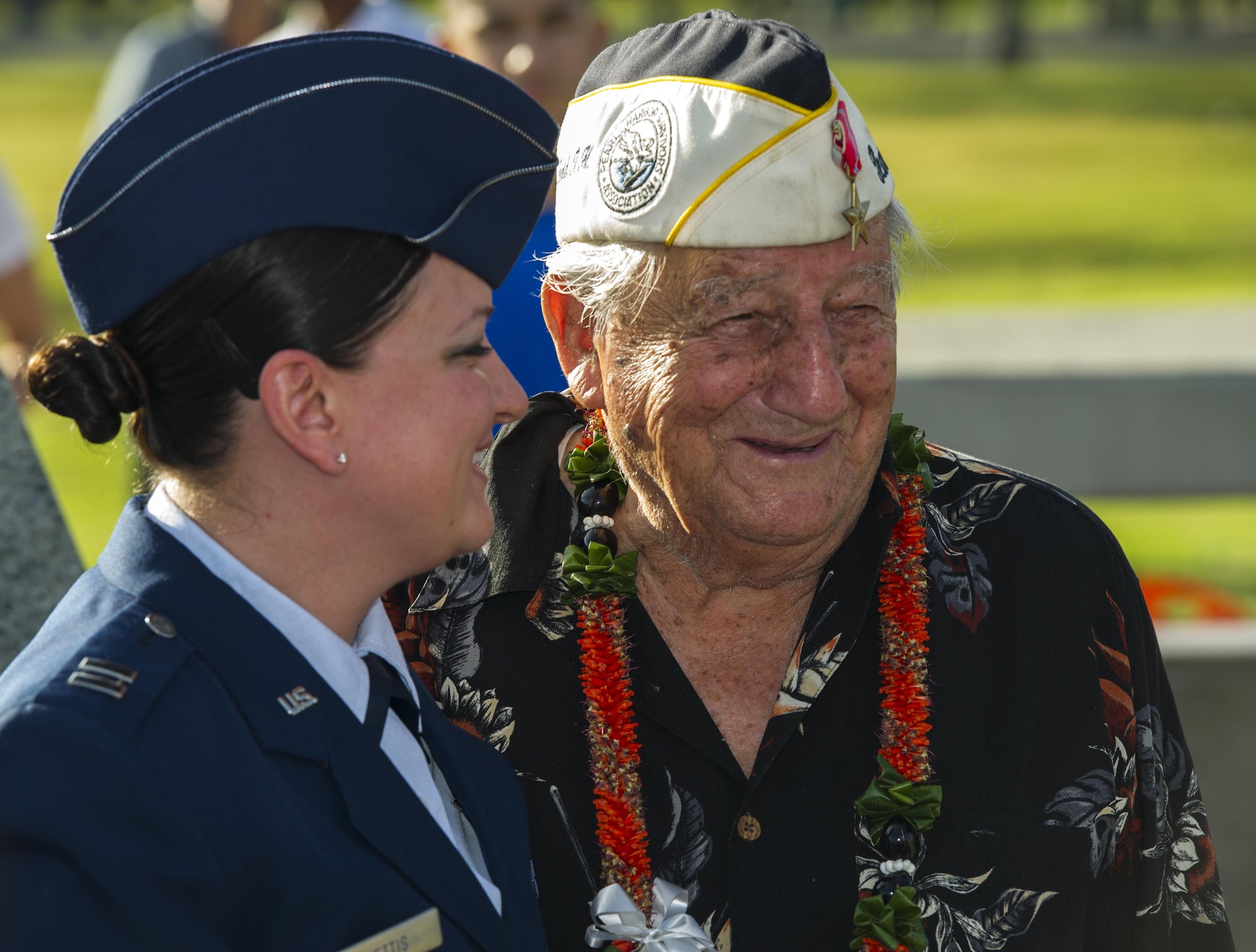 Capt. Kimber Nettis, 515th Air Mobility Operation Wing Cyberspace Operations chief, smiles with Command Sgt. Maj. Armando Galella, a veteran who lost his best friend during the Dec. 7, 1941 attacks on Oahu, during a photo-opportunity session after the 75th Commemoration of the Dec. 7, 1941 attack on Hickam Field ceremony Dec. 7, 2016, at Joint Base Pearl Harbor-Hickam, Hawaii. The attacks on seven bases throughout Oahu precipitated America's entry into World War II, and the annual commemoration ceremony is designed to foster reflection, remembrance, and understanding for those affected by the events that took place 75 years ago. (U.S. Air Force photo by Tech. Sgt. Nathan Allen)