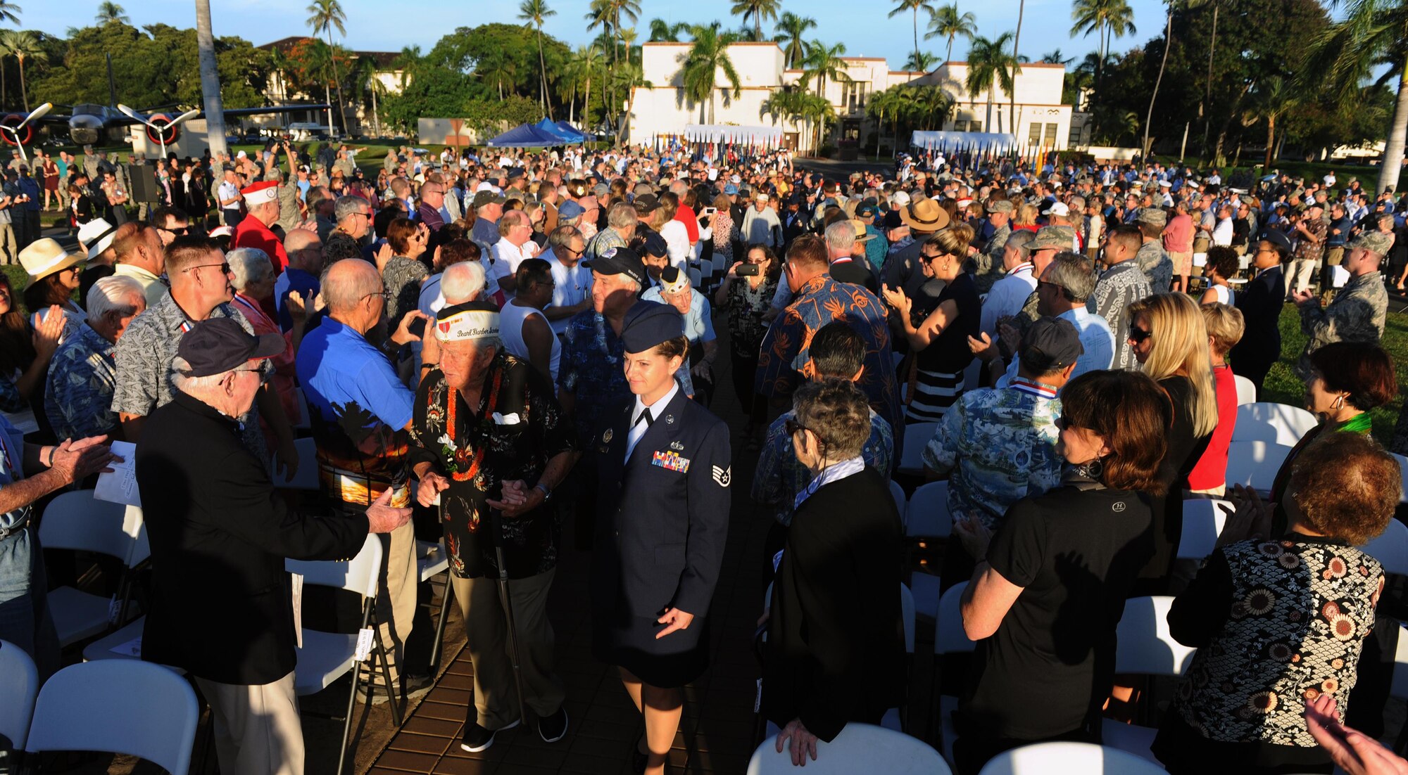 Survivors of the attacks on Pearl Harbor Naval Station and Hickam Field are honored as they enter the 75th Commemoration of the Dec. 7, 1941 Attack on Hickam Field ceremony Dec. 7, 2016, at Joint Base Pearl Harbor-Hickam, Hawaii. The attacks on seven bases throughout Oahu precipitated America's entry into World War II, and the annual commemoration ceremony is designed to foster reflection, remembrance, and understanding for those affected by the events that took place 75 years ago. (U.S. Air Force photo by Tech. Sgt. Nathan Allen)