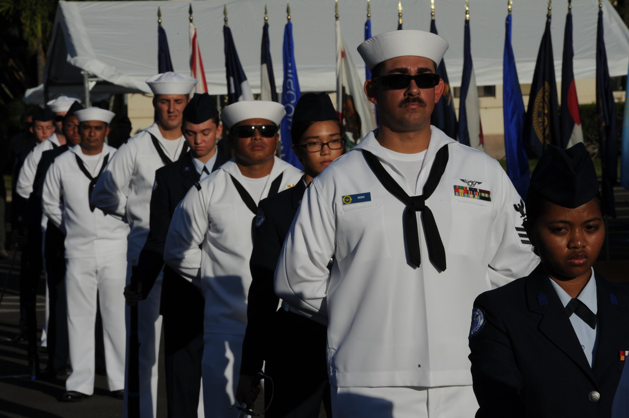 U.S. Air Force and U.S. Navy cadets stand in formation during the 75th Commemoration of the December 7, 1941 attack on Hickam Field ceremony  Dec. 7, 2016, at Joint Base Pearl Harbor-Hickam, Hawaii. The attacks on seven bases throughout Oahu precipitated America's entry into World War II, and the annual commemoration ceremony is designed to foster reflection, remembrance, and understanding for those affected by the events that took place 75 years ago. (U.S. Air Force photo by Tech. Sgt. Nathan Allen)