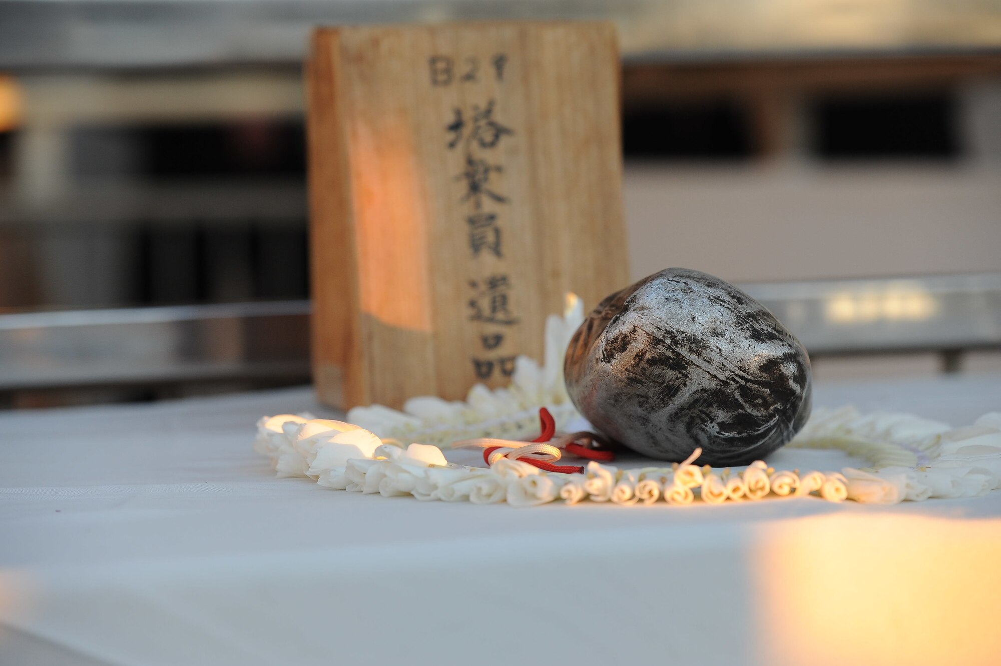 A damaged canteen recovered from the wreckage of a crashed World War II-era B-29 Superfortress in Shizuoka, Japan, is displayed at the USS Arizona Memorial at Joint Base Pearl Harbor-Hickam, Hawaii, during the Blackened Canteen reconciliation ceremony, Dec. 6, 2016. During the annual ceremony, U.S. and Japanese attendees pour a small measure of bourbon over the USS Arizona as an offering of peace and respect to those lost 75 years ago during the attacks on Pearl Harbor and Oahu. (U.S. Air Force photo by Senior Airman Bryan Andrews)