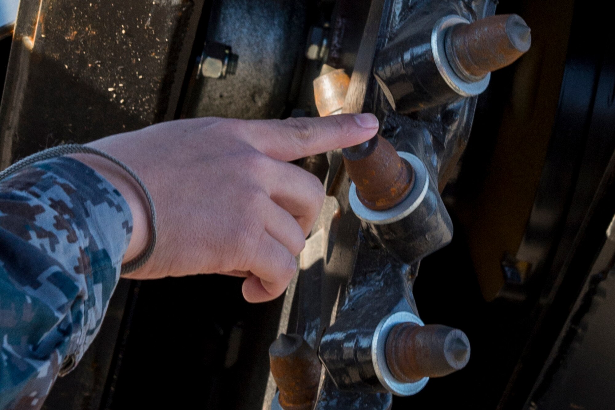 A Japan Air Self Defense Force member touches a piece of machinery during a 374th Civil Engineering Squadrons Rapid Airfield Damage Repair demonstration Dec. 6, 2016, at Yokota Air Base, Japan. In addition to the RADR demonstration, during a three-day course, the 374th CES showed JASDF members techniques and capabilities in; explosive ordinance disposal, air field damage plotting and chemical, biological, radiological and nuclear defense. (U.S. Air Force photo by Airman 1st Class Donald Hudson/Released)