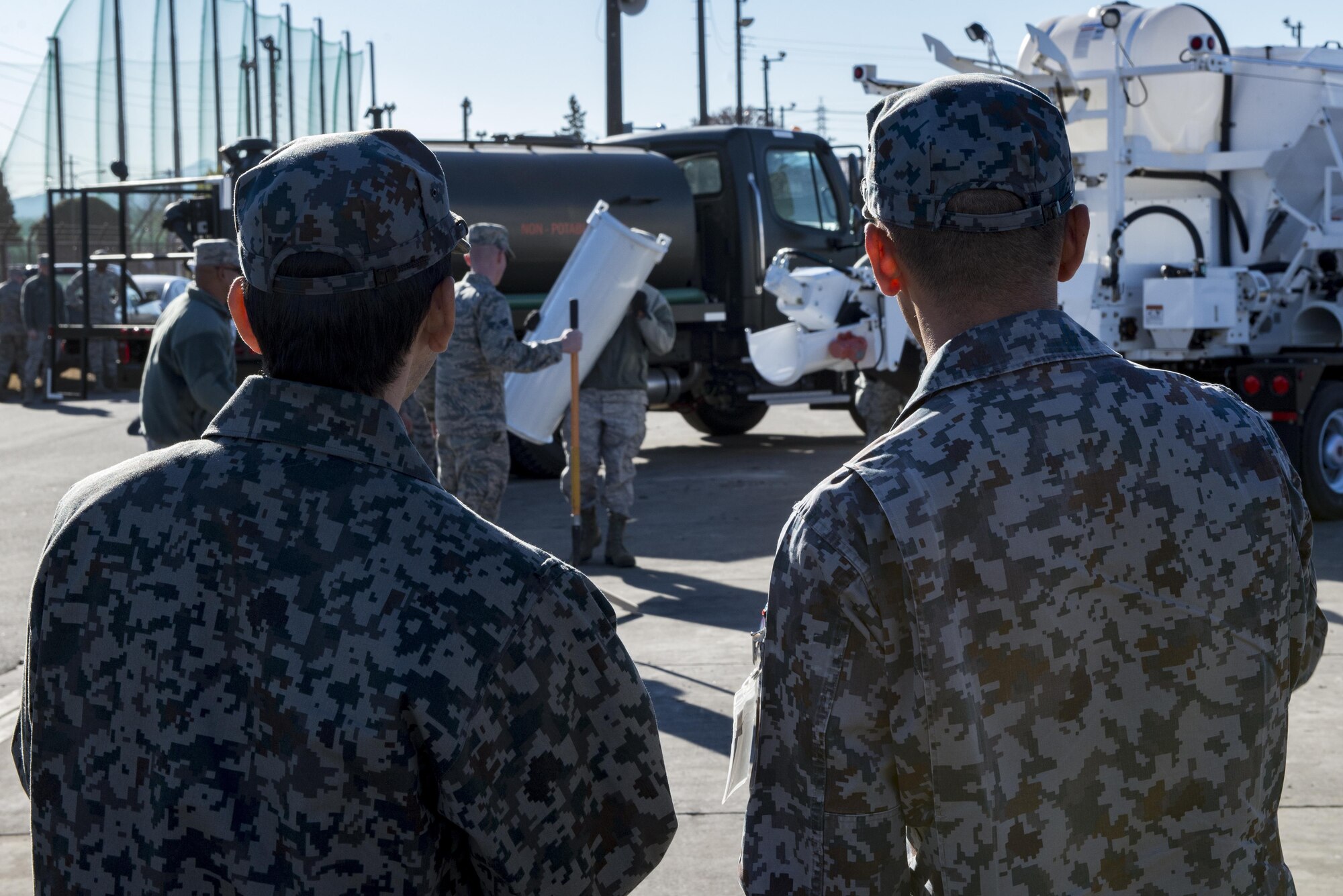 Japan Air Self Defense Force members watch a 374th Civil Engineering Squadrons Rapid Airfield Damage Repair demonstration Dec. 6, 2016, at Yokota Air Base, Japan. The RADR demonstration was a vital tool in sharing both U.S. and Japans engineering capabilities, and to capitalize on best practices between the two forces. (U.S. Air Force photo by Airman 1st Class Donald Hudson/Released)
