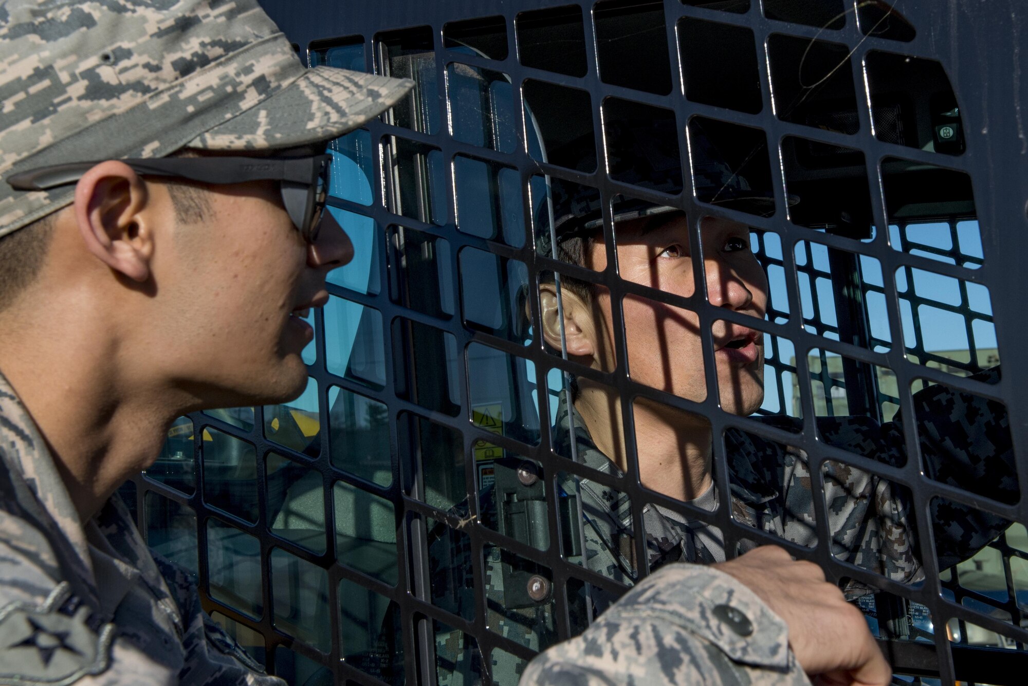 U.S. Air Force Airman 1st Class Alexander J. Love-Gaunt, 374th Civil Engineering Squadron water and fuels systems maintenance apprentice, teaches a Japan Air Self Defense Force member how to operate new equipment during a Rapid Airfield Damage Repair demonstration Dec. 6, 2016, at Yokota Air Base, Japan. The purpose of the RADR demonstration is to share capabilities and techniques with JASDF members in the event of an airfield attack and to promote bilateral engagement between the U.S. and Japan. (U.S. Air Force photo by Airman 1st Class Donald Hudson/Released)