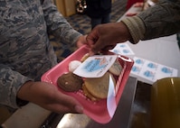 U.S. Air Force Airmen package cookies for delivery during the annual Cookie Caper event at Misawa Air Base, Japan, Dec. 7, 2016. After the cookies are divided and packaged, first sergeants and other leadership across the base hand delivered them to their units.  (U.S. Air Force photo by Senior Airman Deana Heitzman)