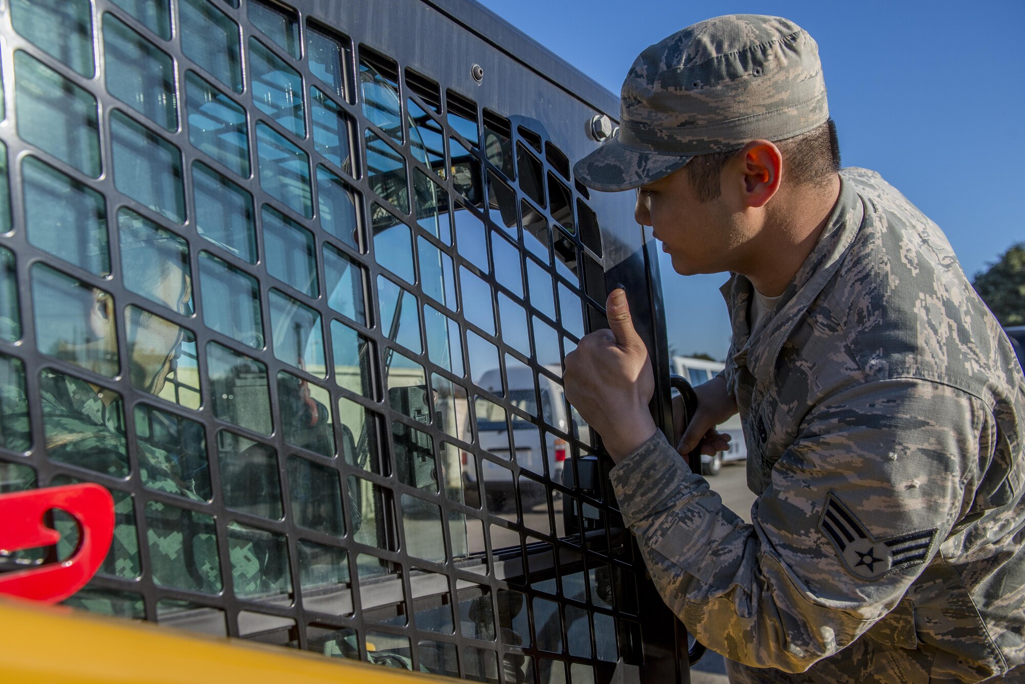 U.S. Air Force Senior Airman Christianpaul Z. Leyson, 374th Civil Engineering Squadron water and fuels systems maintenance journeyman, gives a thumbs up while teaching a Japan Air Self Defense Force member how to use new equipment during a Rapid Airfield Damage Repair demonstration Dec. 6, 2016, at Yokota Air Base, Japan. The purpose of the RADR demonstration is to share capabilities and techniques with JASDF members in the event of an airfield attack and to promote bilateral engagement between the U.S. and Japan. (U.S. Air Force photo by Airman 1st Class Donald Hudson/Released)