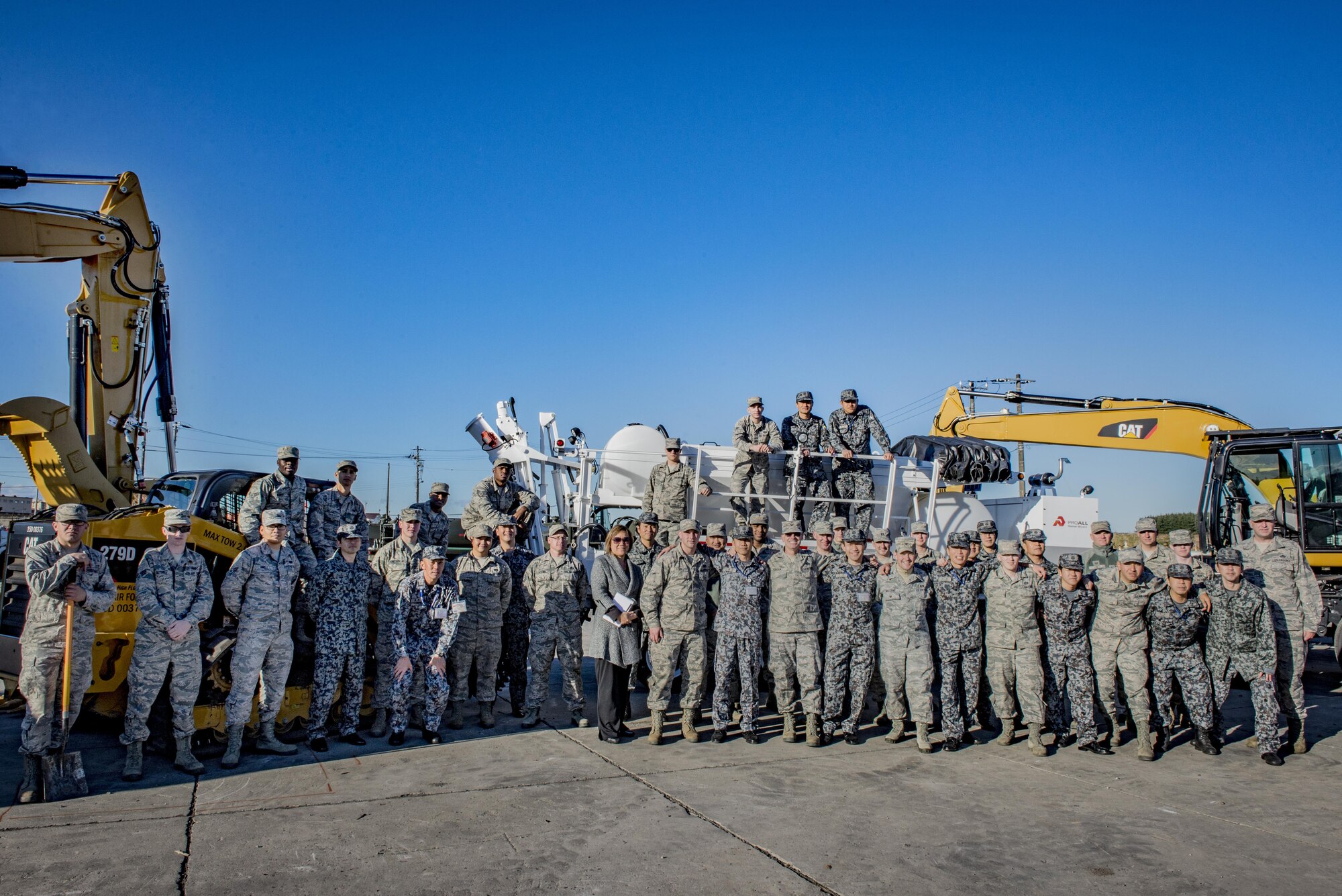 Members of the Japan Air Self Defense Force and 374th Civil Engineering Squadron pose for a photo after participating in a Rapid Airfield Damage Repair demonstration Dec. 6, 2016, at Yokota Air Base, Japan. In addition to the RADR demonstration, during a three-day course, the 374th CES showed JASDF members techniques and capabilities in; explosive ordinance disposal, air field damage plotting and chemical, biological, radiological and nuclear defense. (U.S. Air Force photo by Airman 1st Class Donald Hudson/Released)