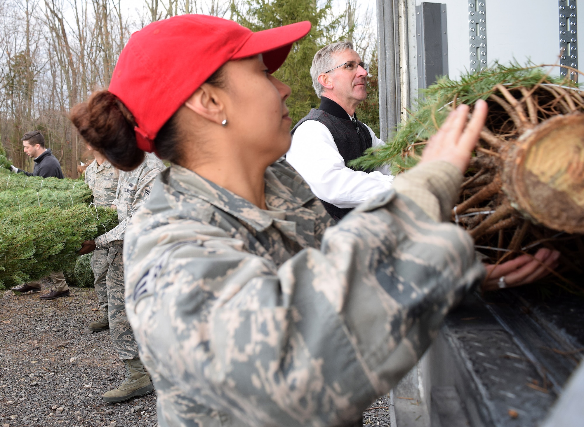 Senior Airman Ramona Navarro, heavy equipment mechanic with the 201st Rapid Engineer Deployable Heavy Operational Repair Squadron Engineer Squadron, Det. 1. teams with Pa. Secretary of Agriculture, Russell Redding to load nearly 100 Christmas trees during the kickoff of the Trees for Troops program at Bustard’s Tree Farm in Lansdale, Pa. on Dec. 2, 2016. The project’s goal is to help provide holiday memories to military members and their families across the U.S. and abroad. (U.S. Air National Guard photo by Master Sgt. Christopher Botzum)
