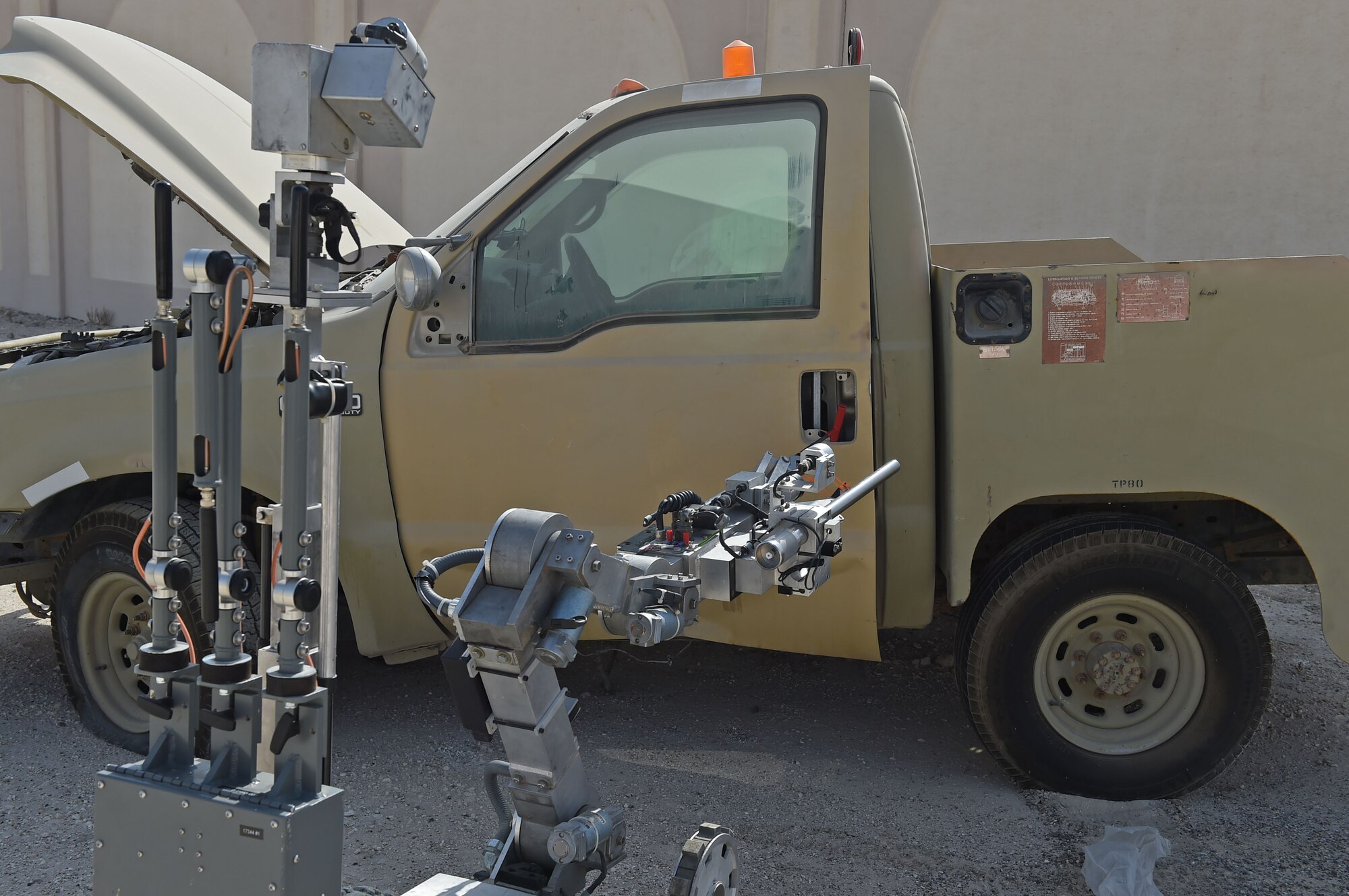 380th Expeditionary Explosive Ordnance Disposal technicians use a remotely controlled robot to inspect a vehicle that is suspected to contain explosive materials during training at an undisclosed location in Southwest Asia, Nov. 25, 2016. Several cameras mounted on the robot allow EOD controllers to visually inspect a scene without being in danger. (U.S. Air Force photo by Tech. Sgt. Christopher Carwile)
