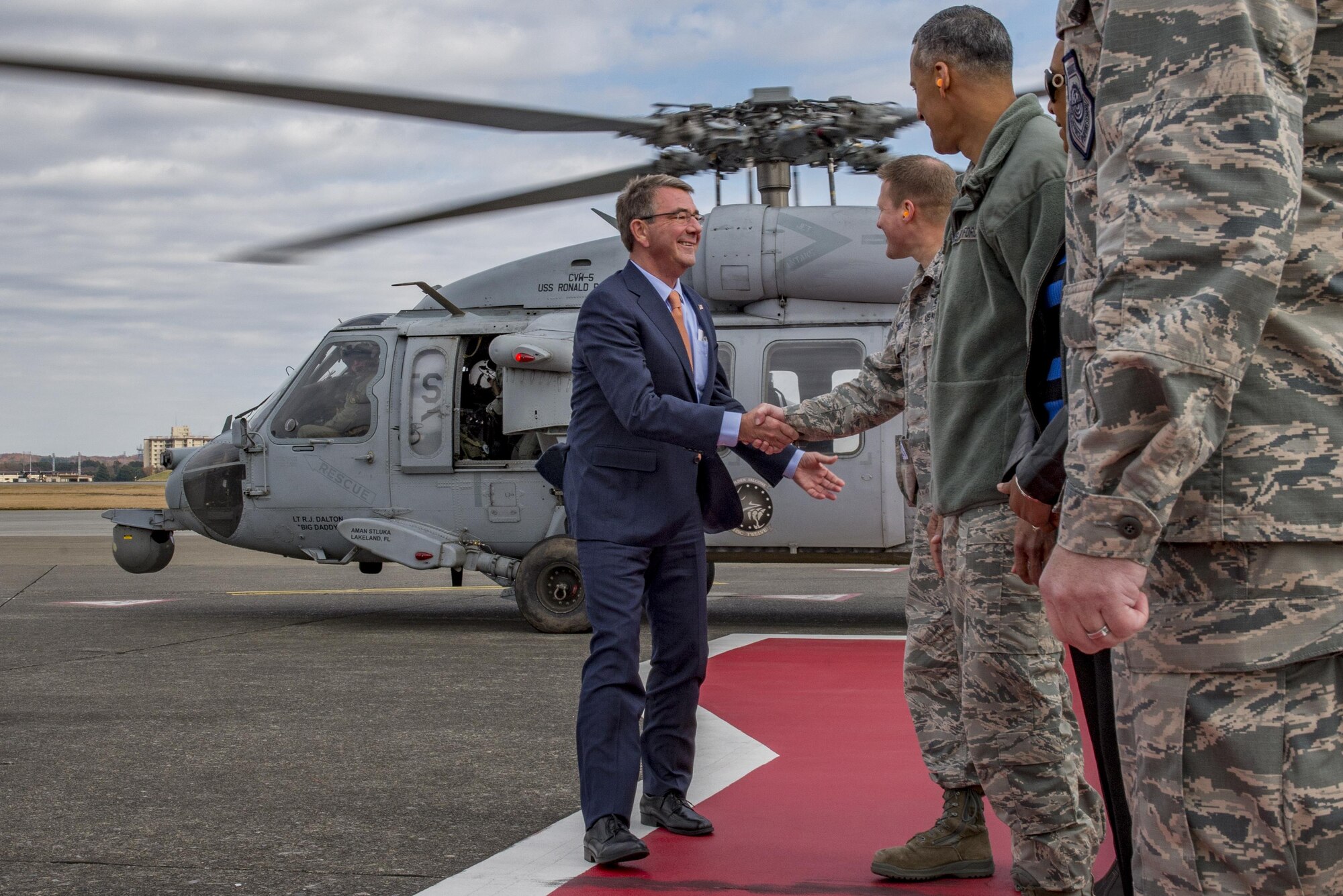 U.S. Secretary of Defense Ashton B. Carter shakes hands with members of the official greeting party on Dec. 5, 2016 upon arrival to Yokota Air Base, Japan. Carter stopped at Yokota during his travel to U.S. military instillations across the world, with plans to thank deployed U.S. troops for their service over the holidays. (U.S. Air Force photo by Airman 1st Class Donald Hudson/Released)