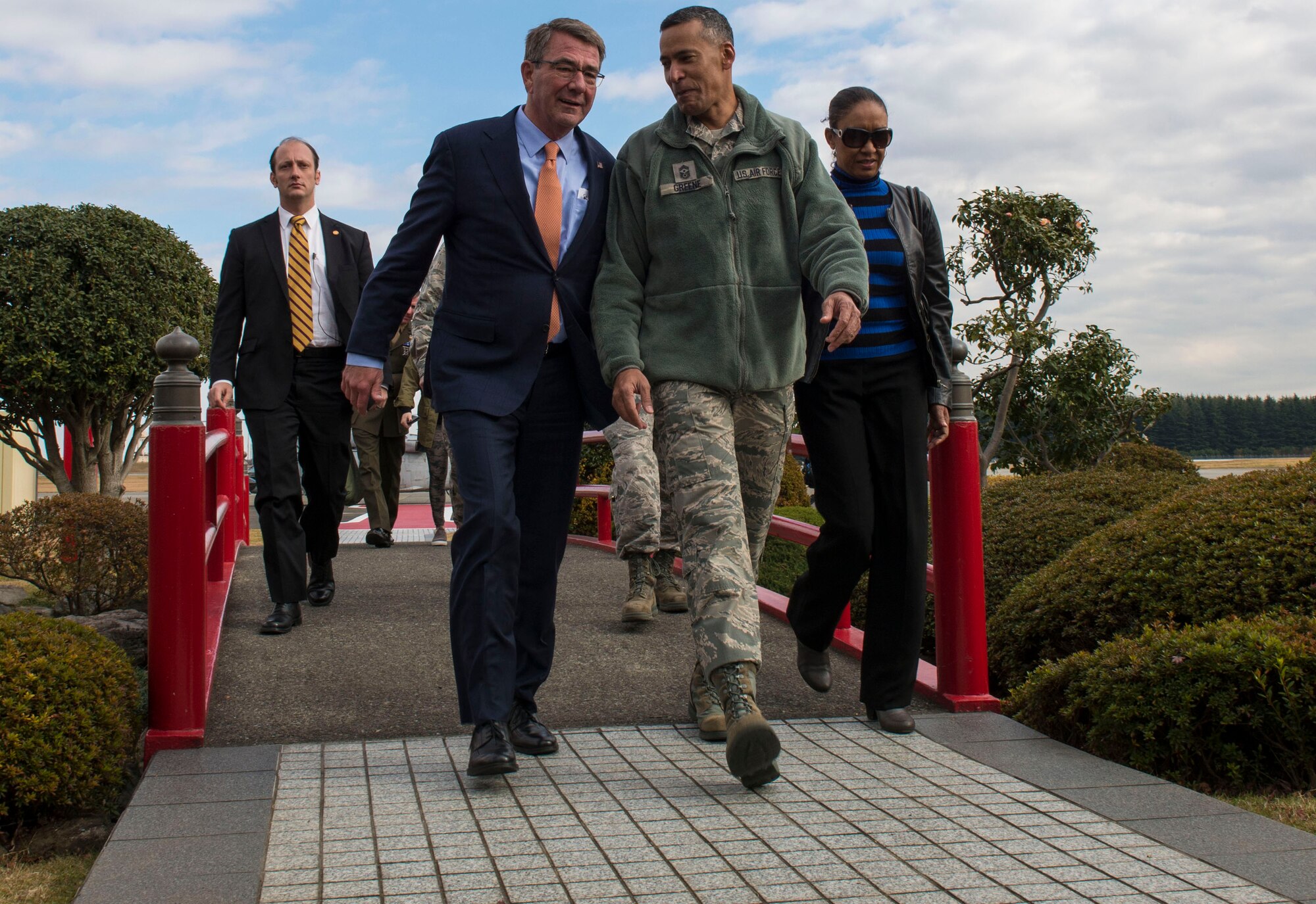 Ashton B. Carter, U.S. Secretary of Defense, left, and Chief Master Sgt. Terrence A. Greene, U.S. Forces Japan and 5th Air Force command chief master sergeant, walk through the distinguished visitor garden Dec. 7, 2016, at Yokota Air Base, Japan. Carter stopped at Yokota during his travel to U.S. military instillations across the world, with plans to thank deployed U.S. troops for their service over the holidays. (U.S. Air Force photo by Airman 1st Class Juan Torres/Released)