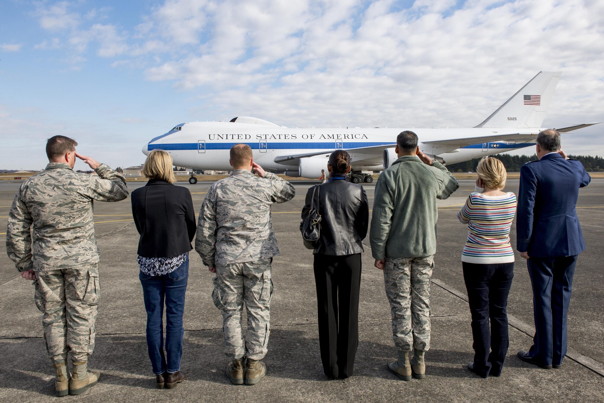 The official departure party salutes U.S. Secretary of Defense Ashton B. Carter during takeoff on Dec. 7, 2016 at Yokota Air Base, Japan. Carter stopped at Yokota during his travel to U.S. military instillations across the world, with plans to advance U.S. priorities including the rebalance to the Asia-Pacific region. (U.S. Air Force photo by Airman 1st Class Donald Hudson/Released)