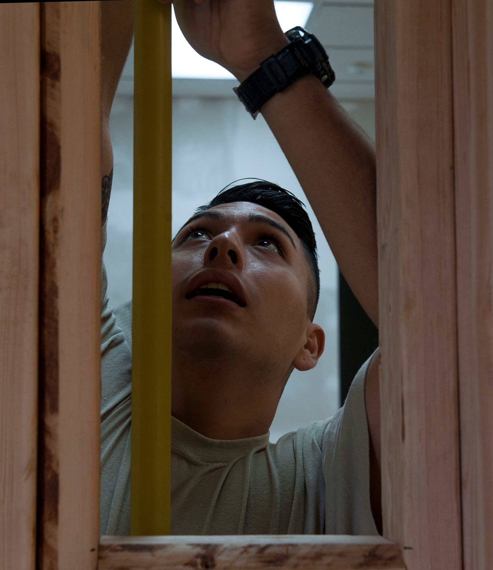 U.S. Air Force Airman 1st Class Jacob Vigil, 18th Civil Engineer Squadron structural apprentice, measures a wall frame for drywall Dec. 7, 2016, at Kadena Air Base, Japan. Checking for proper measurements for drywall ensures a strong interior wall. (U.S. Air Force photo by Senior Airman Lynette M. Rolen/Released)