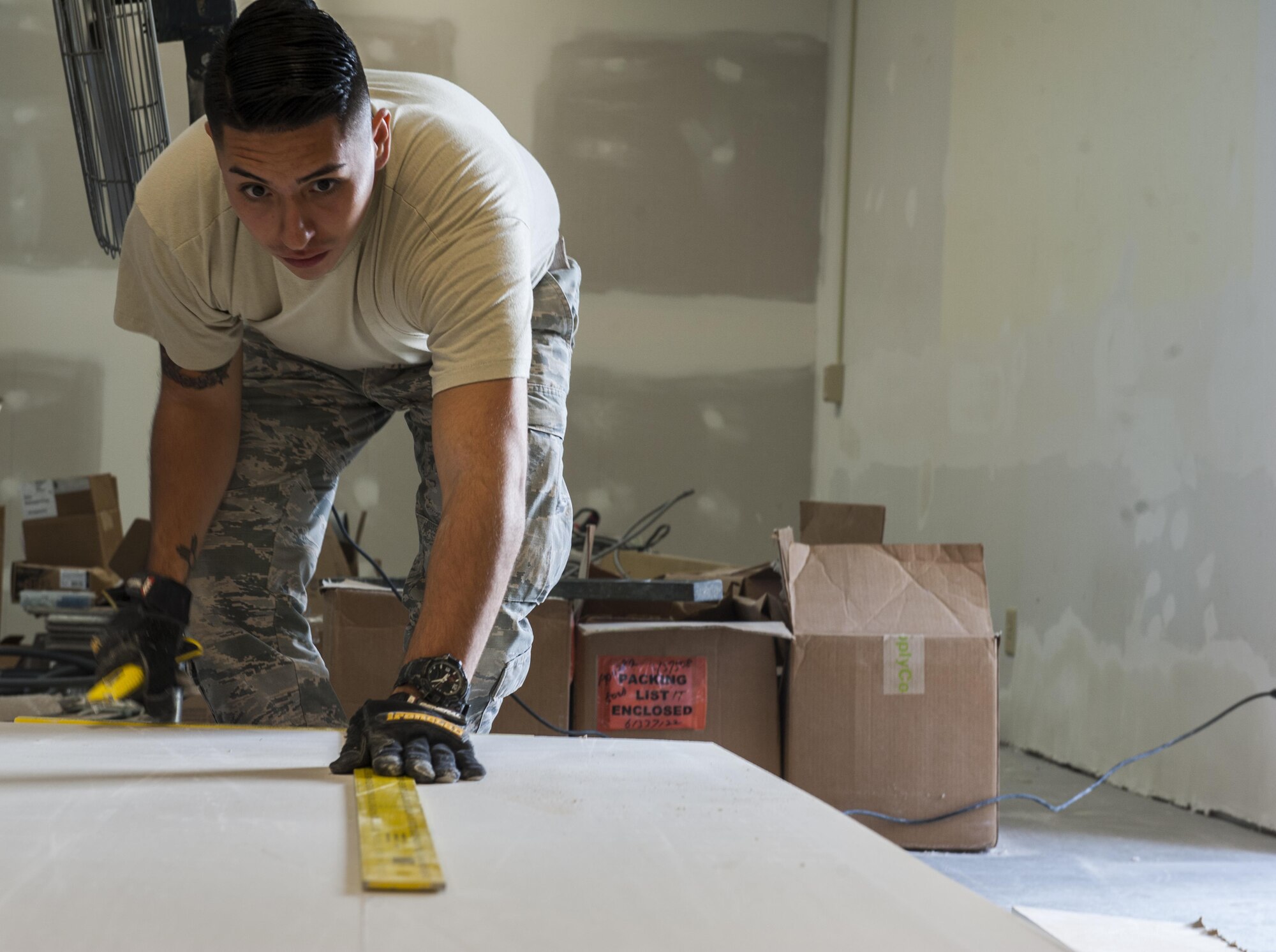 U.S. Air Force Airman 1st Class Jacob Vigil, 18th Civil Engineer Squadron structural apprentice, measures drywall Dec. 7, 2016, at Kadena Air Base, Japan. Drywall serves a vital purpose of guaranteeing strong interior walls. (U.S. Air Force photo by Senior Airman Lynette M. Rolen/Released)