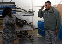 Senior Airman Daneeka Mucker, 86th Logistics Readiness Squadron hazardous material pharmacy journeyman, salutes Lt. Gen. Richard M. Clark, Third Air Force and 17th Expeditionary Air Force commander, after being coined at Ramstein Air Base, Germany, Dec. 2, 2016. Mucker was recognized for her outstanding Airmanship and for providing honor guard support for the Third Air Force change of command. (U.S. Air Force photo by Senior Airman Jimmie D. Pike)