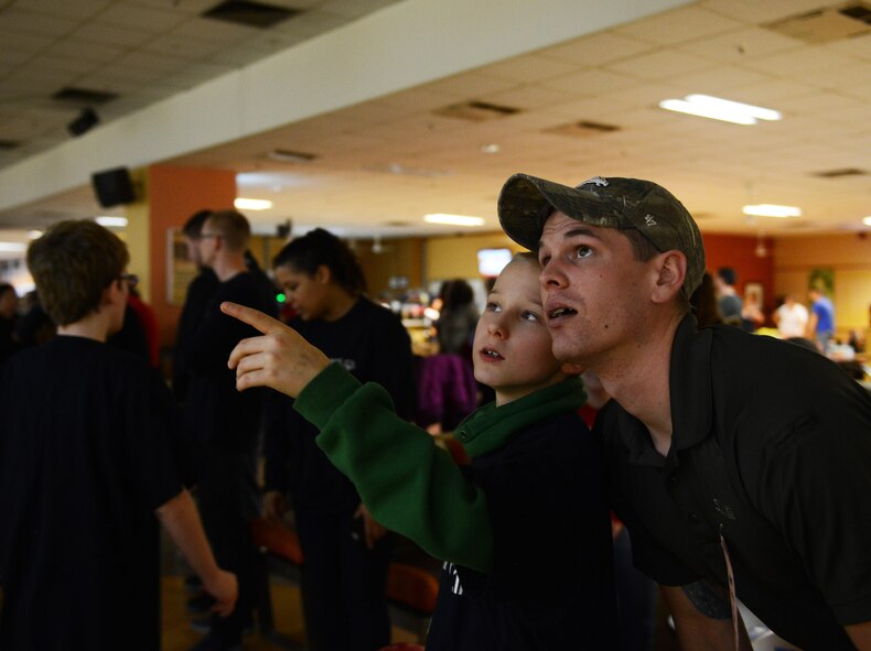 Staff Sgt. Aaron Wilcox, 569th U.S. Forces Police Squadron combat arms instructor, assists a Special Olympics participant choose the settings for a game of bowling at Vogelweh Military Complex, Germany, Dec. 2, 2016. Volunteers from around the Kaiserslautern Military Community gathered at the event to interact with special needs children, both Germans and Americans, to help them enhance their social skills and boost their self-confidence. (U.S. Air Force photo by Airman 1st Class Joshua Magbanua)