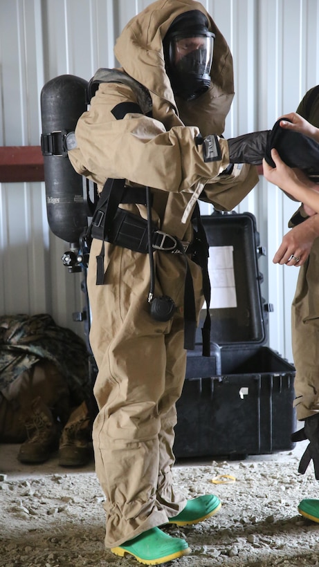 A Marine suits-up in his Assessment Consequence Management gear during a field exercise at Marine Corps Outlying Field Atlantic, N.C., Nov. 30, 2016. Twenty-two Marines with Chemical, Biological, Radiological and Nuclear Defense, 2nd Marine Aircraft Wing, conducted a week-long annual training exercise to refresh the defense specialists on the roots of their basic military occupational specialty training. The exercise included an assortment of stations and classes that tested the Marines physically and mentally, including {put the things it included here}. (U.S. Marine Corps photo by Lance Cpl. Mackenzie Gibson/Released)