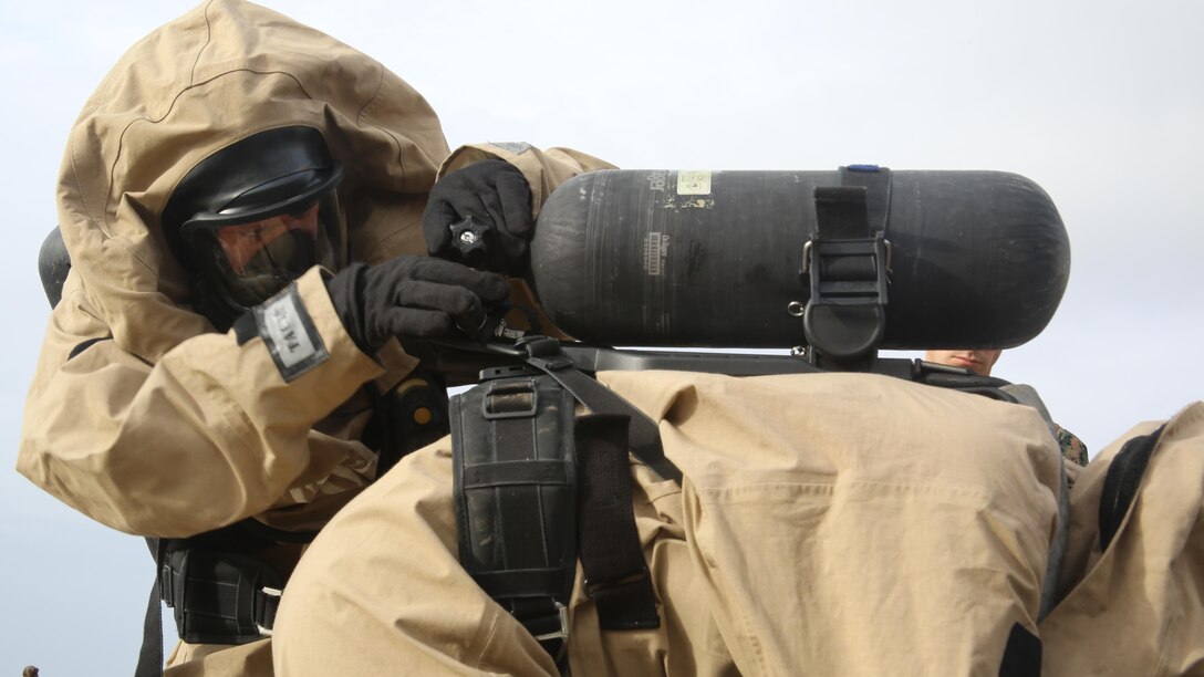 A Marine swaps another Marine’s empty air tank with a full tank during a field exercise at Marine Corps Outlying Field Atlantic Nov. 30, 2016. Twenty-two Marines with Chemical, Biological, Radiological and Nuclear Defense, 2nd Marine Aircraft Wing, conducted a week-long annual training exercise that refreshed the defense specialists on the roots of their basic military occupational specialty training. The exercise included an assortment of stations and classes that tested the Marines physically and mentally. (U.S. Marine Corps photo by Lance Cpl. Mackenzie Gibson/Released)