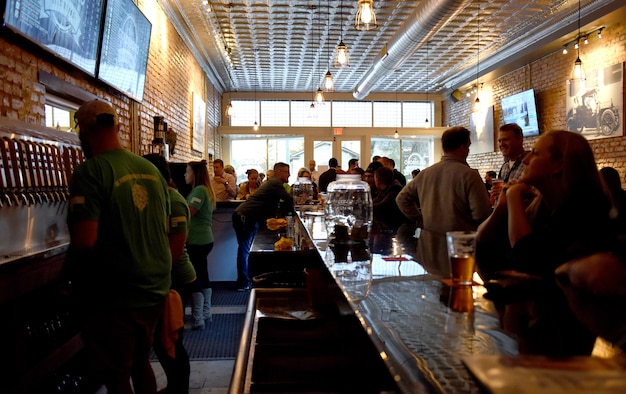 Goldsboro Brew Works, a veteran owned company, celebrates its grand opening, Dec. 2, 2016, in Downtown Goldsboro, North Carolina. Clark and Fein, former F-15E Strike Eagle crew chiefs at Seymour Johnson Air Force Base, began the renovation process for their business by building the bar and tables from scratch. (U.S. Air Force photo by Airman Miranda A. Loera)