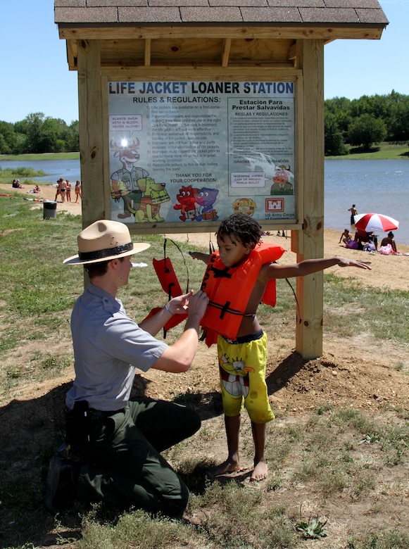 Park rangers promote water safety and assist with finding loaner life jackets and correct fitting.