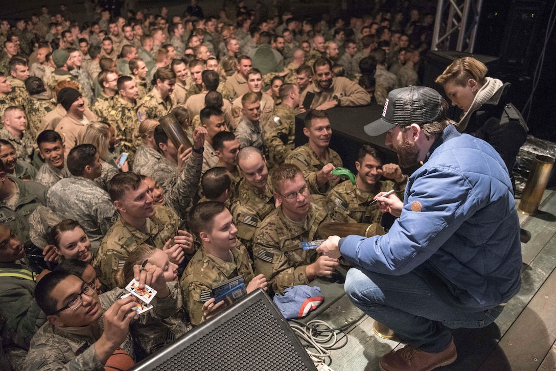 Scarlett Johansson and Chris Evans sign autographs for service members during the USO Holiday Tour at Incirlik Air Base, Dec. 5, 2016. Marine Gen. Joseph F. Dunford, Jr., chairman of the Joint Chiefs of Staff, and USO entertainers, will visit service members who are deployed from home during the holidays at various locations across the globe. This year’s entertainers included actor Chris Evans, actress Scarlett Johansson, NBA Legend Ray Allen, 4-time Olympic Medalist Maya DiRado, Country Music Singer Craig Campbell, and mentalist Jim Karol. (DoD photo by Navy Petty Officer 2nd Class Dominique A. Pineiro/Released)