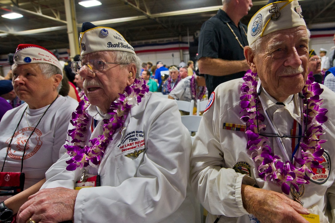 Pearl Harbor survivor and Navy veteran Delton Walling, right, Sons and Daughters of Pearl Harbor Survivors member Joanne Ericksen, left, and her father, Pearl Harbor survivor and Navy veteran Mel Heckman, attend the commemoration for the 75th anniversary of the Pearl Harbor attack, at Joint Base Pearl Harbor-Hickam, Hawaii, Dec. 7, 2016. DoD photo by Lisa Ferdinando