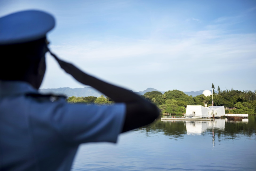 Navy Ensign Sheryl Acuna renders honors aboard the guided-missile destroyer USS Halsey during a pass in review of the USS Arizona Memorial at the 75th Pearl Harbor Commemoration Ceremony, Pearl Harbor, Hawii, Dec. 7, 2016. Navy photo by Petty Officer 2ndClass Aiyana Paschal