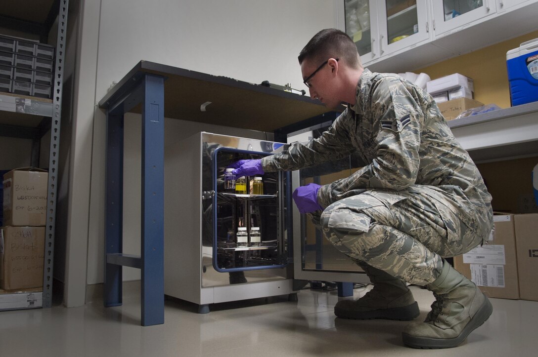 Airman 1st Class Brandon Lees, 779th Aerospace Medicine Squadron bioenvironmental technician, places a sample in an incubator on Joint Base Andrews, Md., Dec. 6, 2016.  The test is incubated for 24 hours to promote growth of any present bacteria. The Airmen perform more than 140 water tests each year and also assess shops for occupational hazards to keep JBA members safe. (U.S. Air Force photo by Senior Airman Mariah Haddenham)
