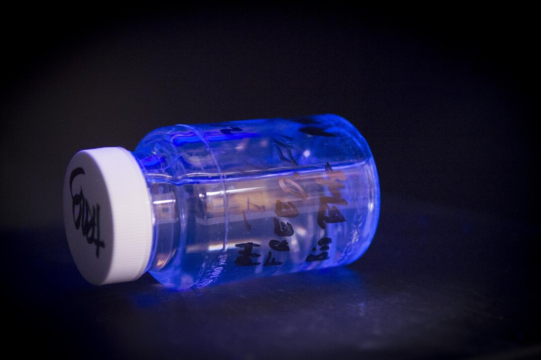 A sample used for training purposes glows luminescent under ultra violet light indicating bacteria presence during training on Joint Base Andrews, Md., Dec. 6, 2016. The test is incubated for 24 hours to promote growth of any bacteria, and will glow luminescent under the UV light if bacteria is present. (U.S. Air Force photo by Senior Airman Mariah Haddenham)