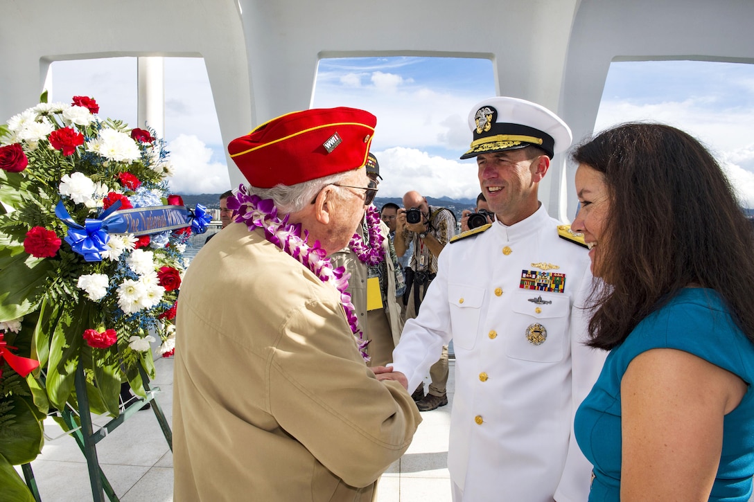 Chief of Naval Operations Navy Adm. John Richardson, center, shakes hands with Pearl Harbor survivor Paul Hilliard during a floral tribute at the USS Arizona Memorial following the conclusion of the 75th Pearl Harbor Commemoration Ceremony, Pearl Harbor, Hawaii, Dec. 7, 2016. Navy photo by Petty Officer 2nd Class Katarzyna Kobiljak