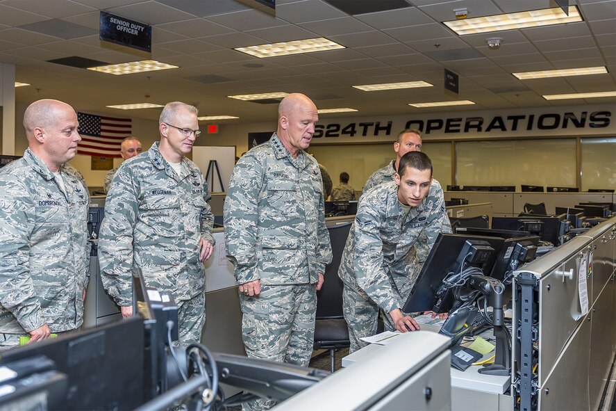 Gen. John Raymond, commander of Air Force Space Command, receives a cyber brief from Airman 1st Class Ryan McClish, 624th Operations Center, Dec. 5, 2016 at Joint Base San Antonio-Lackland. Escorting Gen. Raymond is Maj. Gen. Christopher Weggeman, 24th Air Force commander and Col. Michael Dombrowski, 624th Operations Center commander. (U.S. Air Force photo/Lt. Col. Cade Sonnichsen)