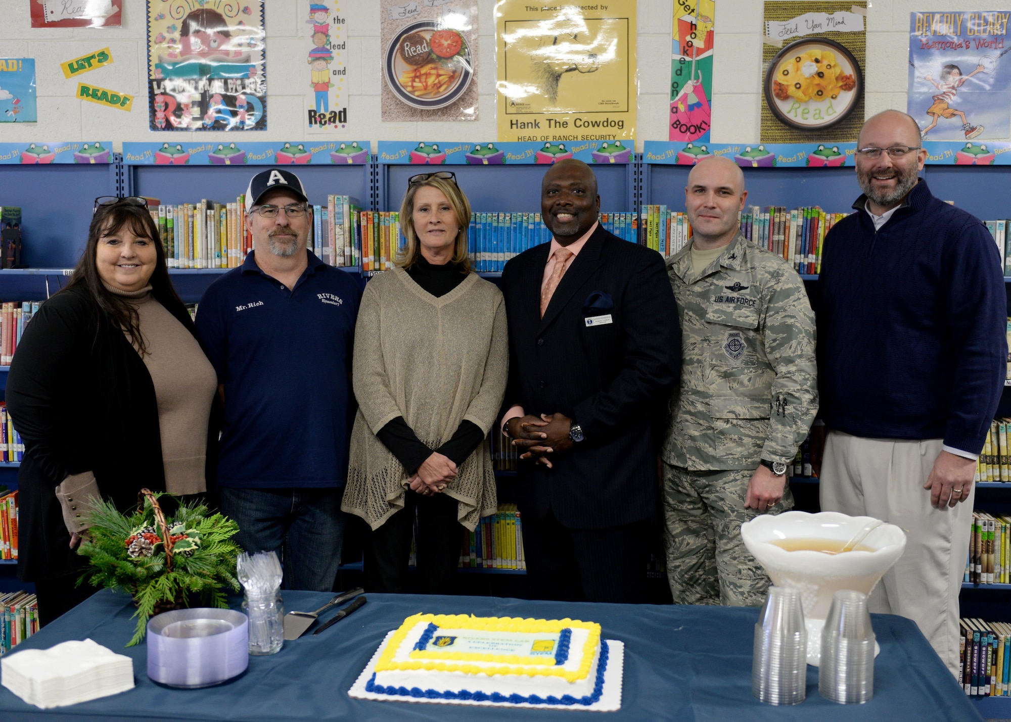 U.S. Air Force Col. Todd Hohn, 97th Air Mobility Wing commander, poses for a photo along with other members who were institutional in opening the STEM lab, December 6, 2016, Altus Air Force Base, Oklahoma. The STEM initiative hopes to inspire the next generation to take an interest in science, technology, engineering and mathematics. (U.S. Air Force Photo by Airman Jackson N. Haddon/Released).