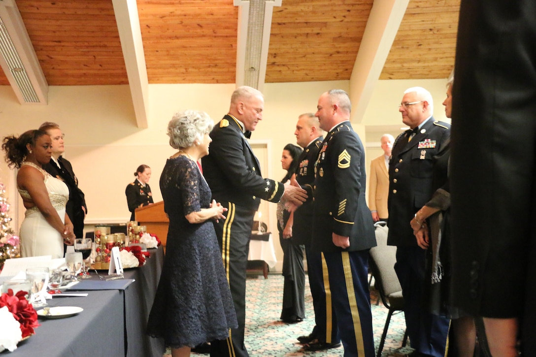 Soldiers from the 811th Ordnance Company, 321st Ordnance Battalion, 38th Regional Support Group, 310th Sustainment Command (Expeditionary), 377th Theater Sustainment Command are awarded the Army Commendation Medal by Maj. Gen. Leslie (Les) J. Carroll, commanding general of the 377th TSC, as Rainelle, W.Va., Mayor Andrea “Andy” Pendleton stands by, during the 321st Ordnance Battalion Dining Out in Daniels, W. Va., Dec. 3, 2016, for their achievements while the unit provided rescue operations, route clearance, and shelter for over 250 members of the local community of Rainelle, W.Va. during historic flooding of 24 through 27 June, 2016.