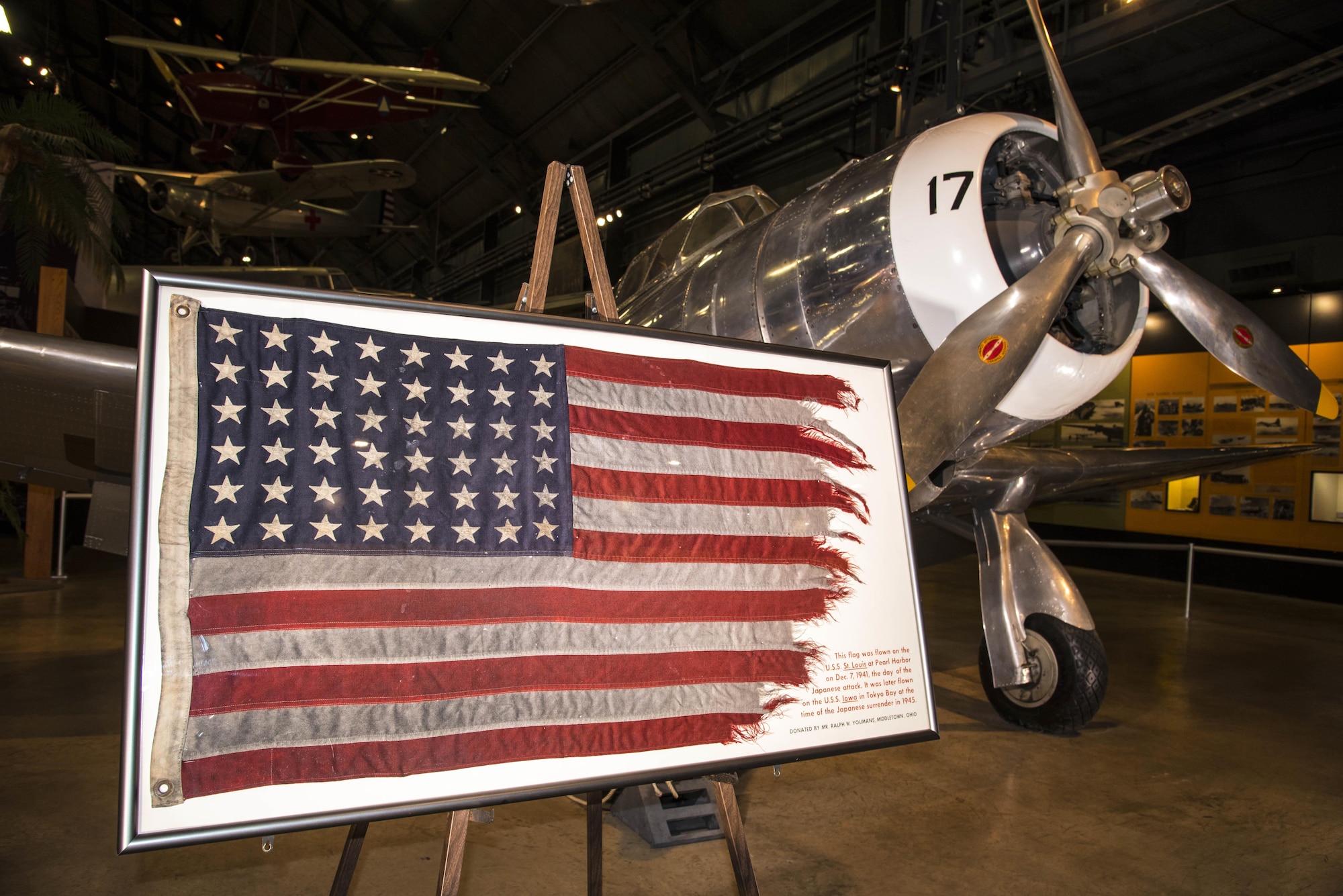 DAYTON, Ohio - This flag was flown on the U.S.S. St. Louis at Pearl Harbor on Dec. 7, 1941, the day of the Japanese attack. It was later flown on the U.S.S. Iowa in Tokyo Bay at the time of the Japanese surrender in 1945. The flag was donated by Mr. Ralph W. Youmans from Middletown, Ohio. The U.S. flag on display has been temporarily removed for conservation treatment. (U.S. Air Force photo by Ken LaRock)