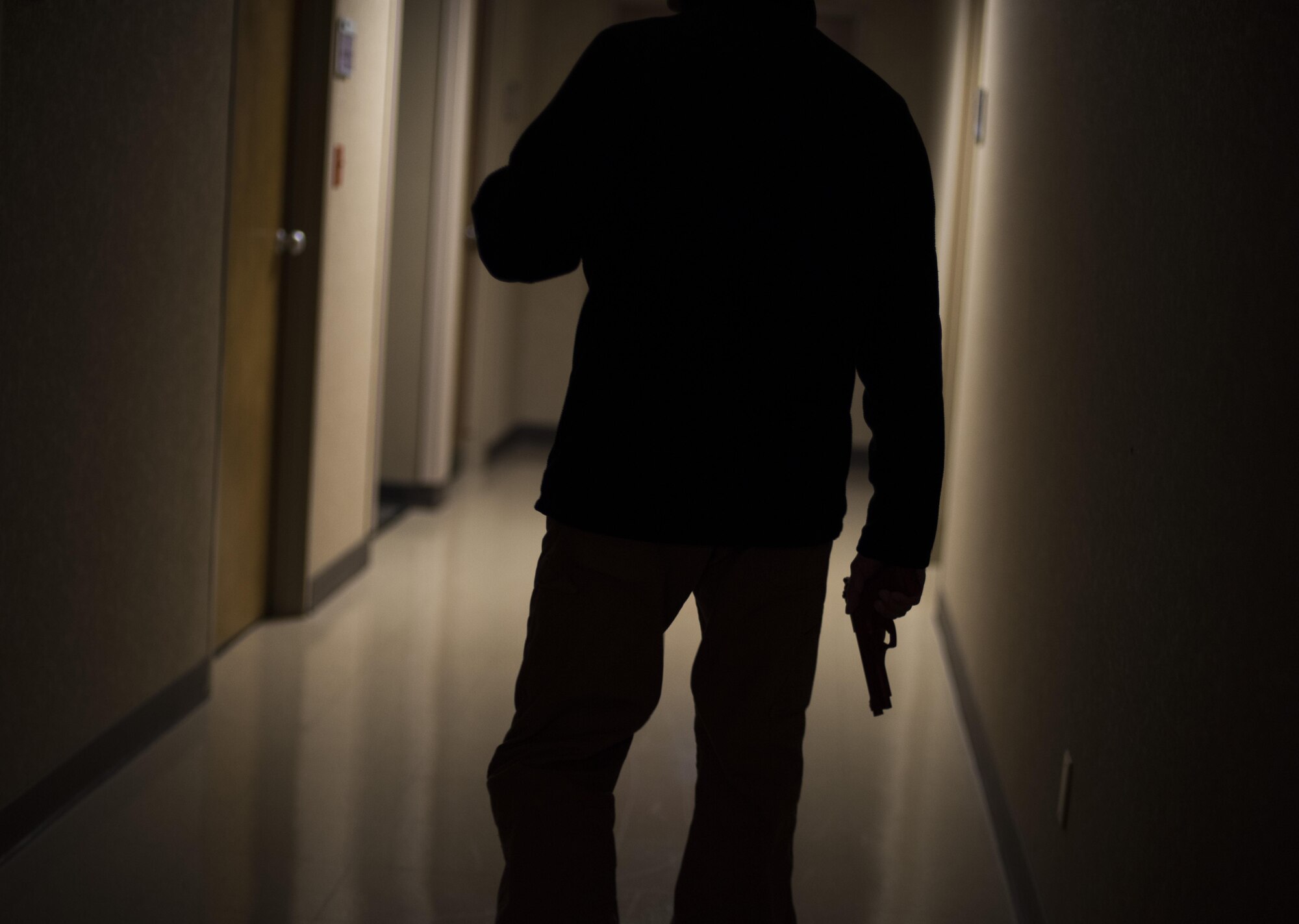 Master Sgt. Jeremy Utphall, 2nd Bomb Wing Inspector General exercise division superintendent, walks down a hallway looking for potential “victims” during an active shooter exercise at Barksdale Air Force Base, La., Nov. 29, 2016. He went throughout the medical building, searching offices for victims. (U.S. Air Force photo/Senior Airman Damon Kasberg)