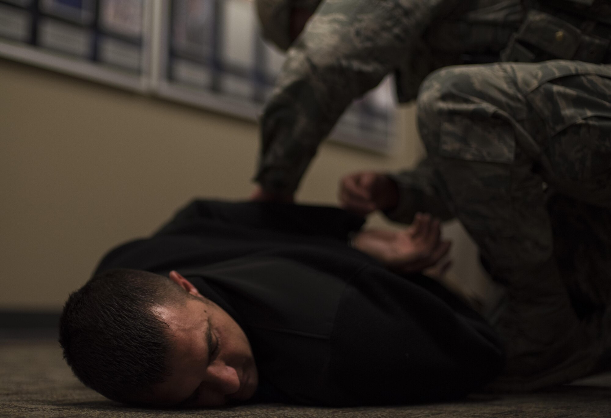 Master Sgt. Jeremy Utphall, 2nd Bomb Wing Inspector General exercise division superintendent, is handcuffed during an active shooter exercise at Barksdale Air Force Base, La., Nov. 29, 2016. Utphall played the role of the active shooter. These types of exercises test how the base responds to any given situation and evaluates base agencies’ response to situations. (U.S. Air Force photo/Senior Airman Damon Kasberg)