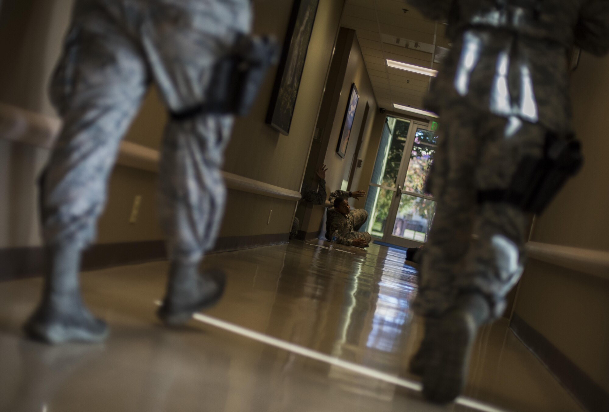 Members of the 2nd Security Forces Squadron search a building for victims and potential threats during an active shooter exercise at Barksdale Air Force Base, La., Nov. 29, 2016. This exercise tested the base's emergency management core capabilities as well as shelter in place and lock down procedures. (U.S. Air Force photo/Senior Airman Damon Kasberg)